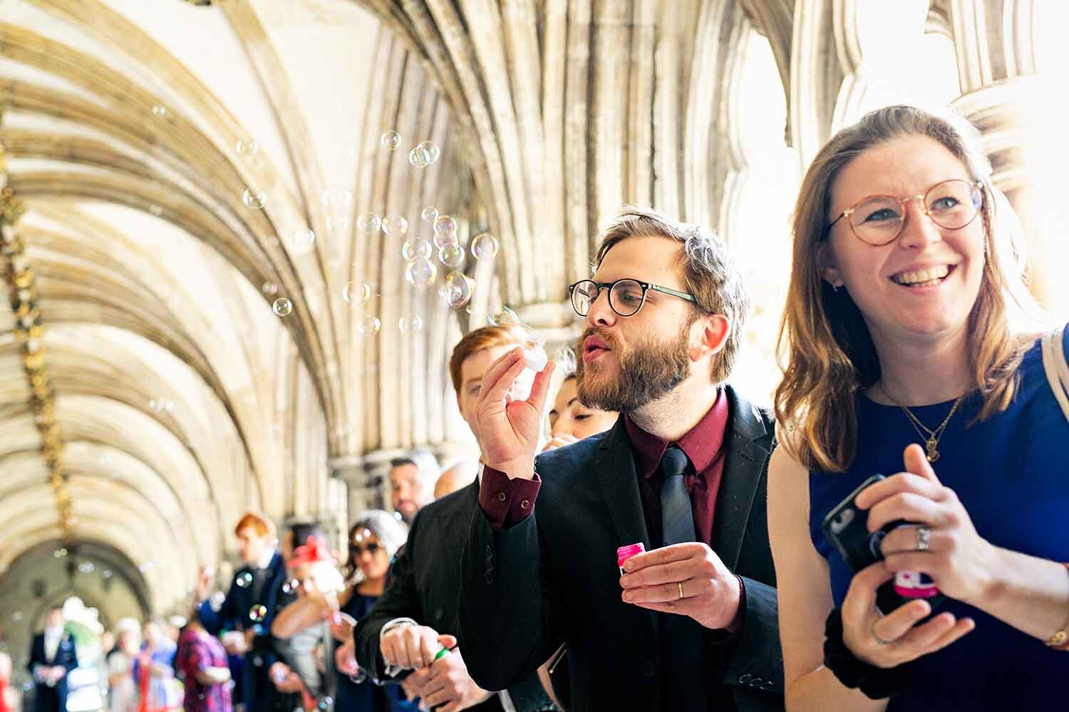 wedding-guest-blowing-bubbles-norwich-cathedral.jpg