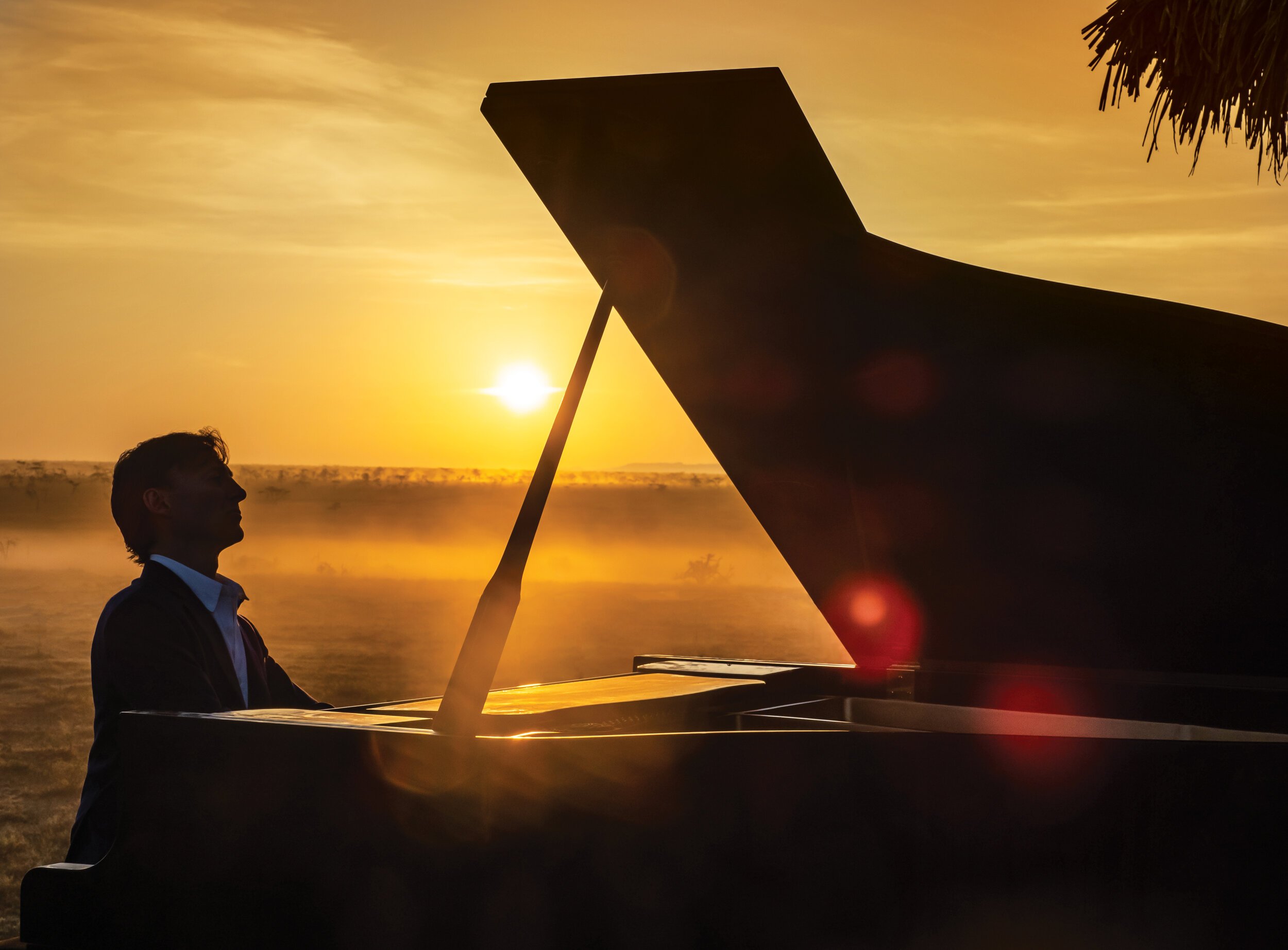 Bruce Levingston at a grand piano at sunrise in Kenya.jpg