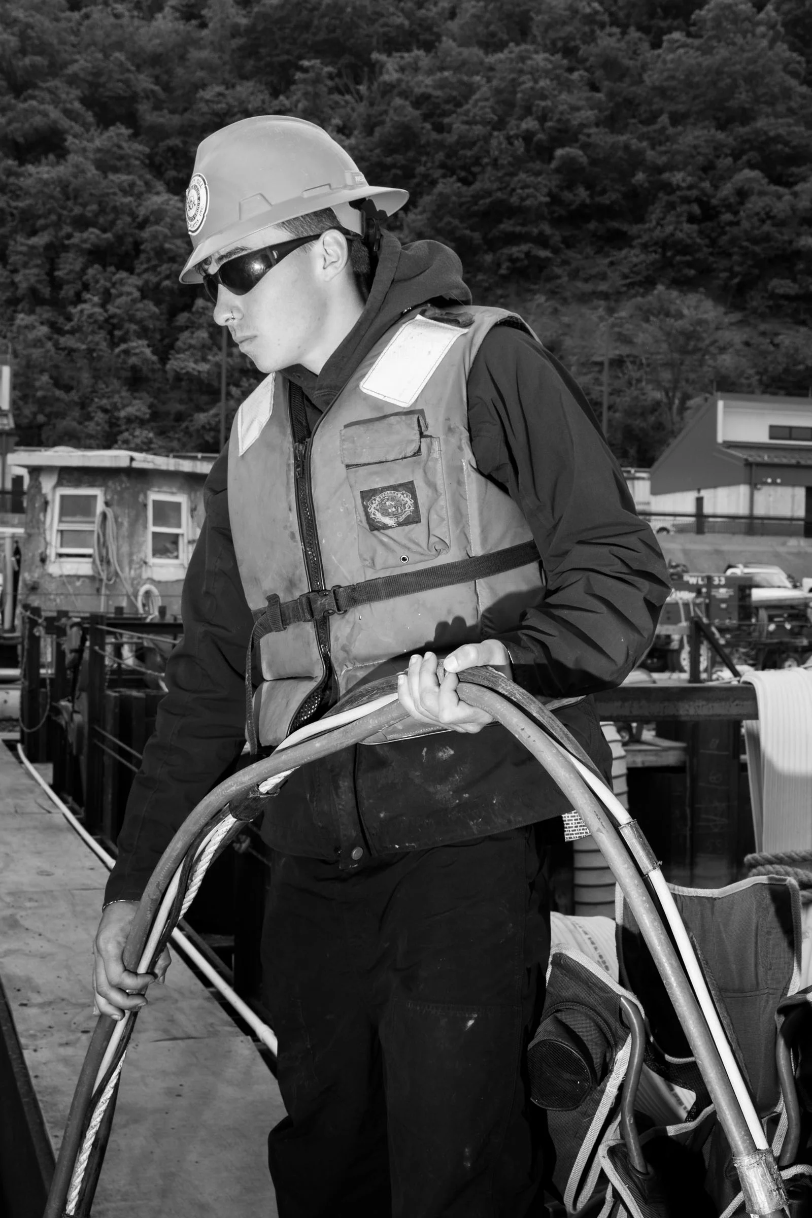 Will Clibbens, a diver tender, feeds hoses that contain warm water (for warmth), air (for breathing), and preasurized air (for tools) to a diver who is working to prepare a section of the new middle wall of the Charleroi Lock for the next phase of construction.
Credit: Jonno Rattman for the Wall Street Journal
Slug: PAWATERWAYS