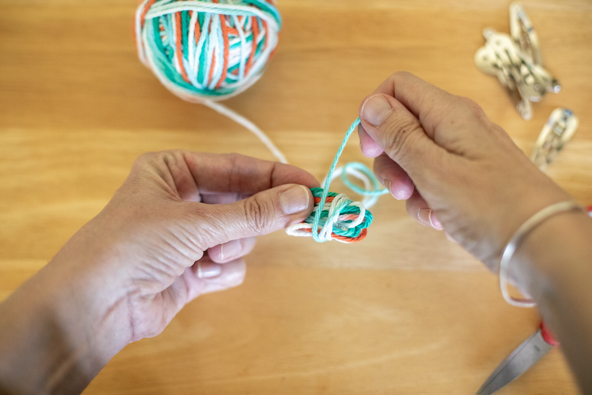  Still holding the loops together with one hand (I use my left), wrap the yarn around the circles a few times around. It doesn’t need to be very tidy (it will be hidden inside the ball). 