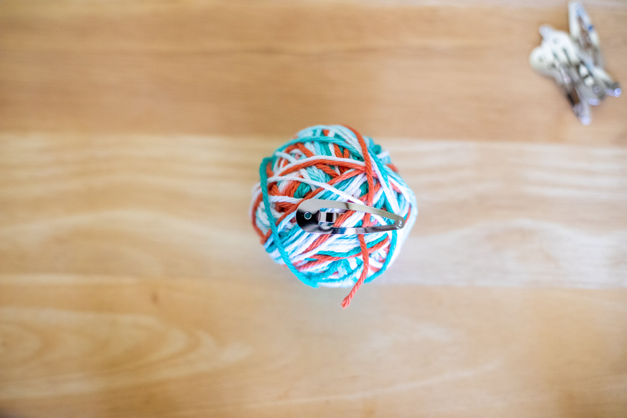  Continue until your ball is a perfect size. You can snip the thread and secure the loose tail with a bit of tape or a springy hairclip. Now you’re ready to start another yarn ball! 
