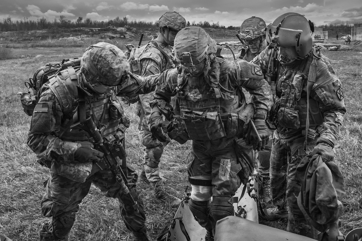 Brotherhood A mock patient is assisted into the DUSTOFF Helicopter during a field training exercise with 1BCT, 10th Mountain Division