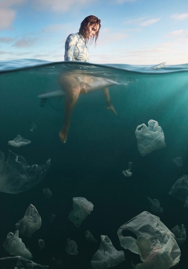 Plastic Bags float like jellyfish beneath a surfer.