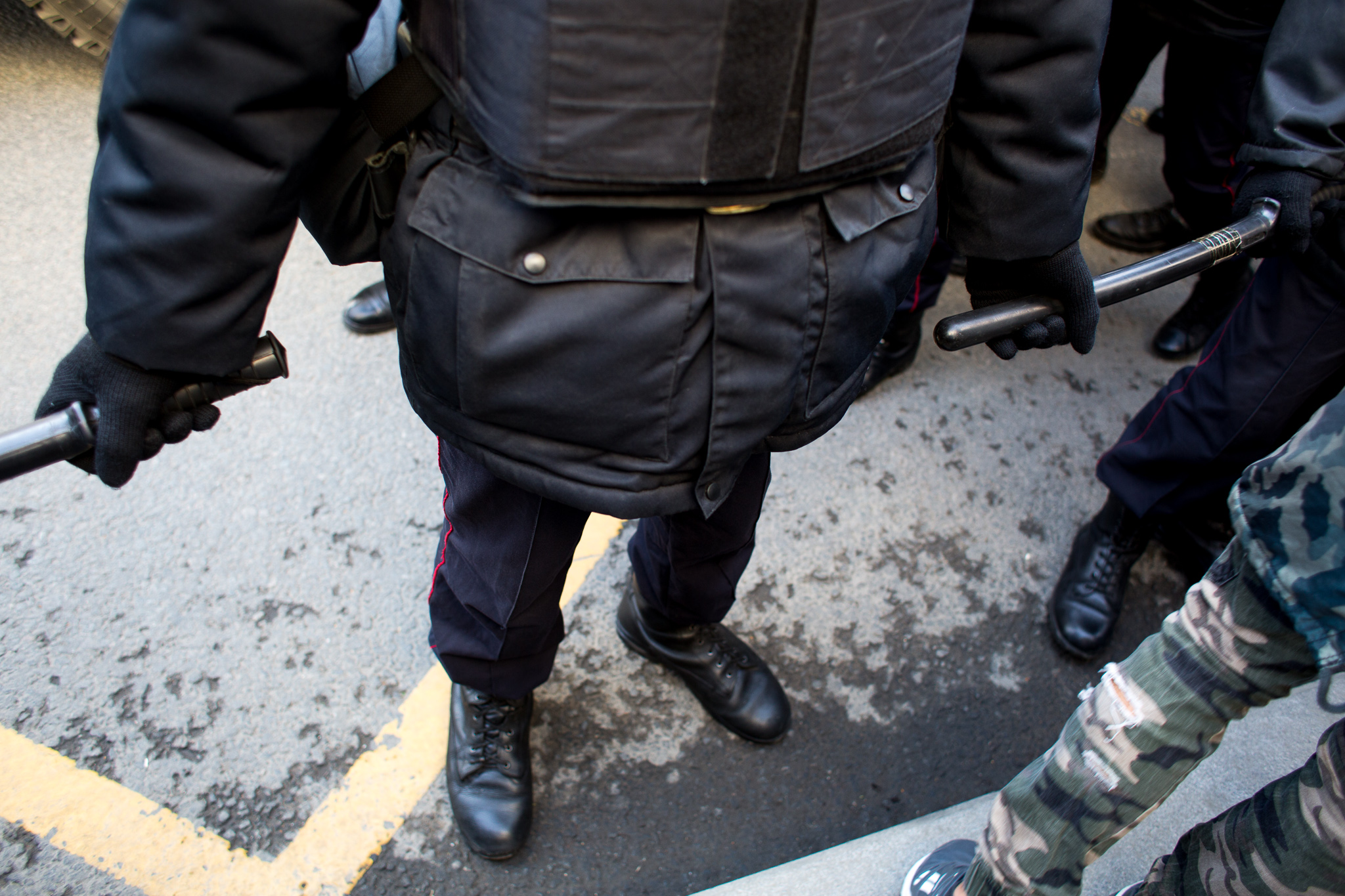 Police barricade the streets, containing protesters to the footpaths as they march against the government.
