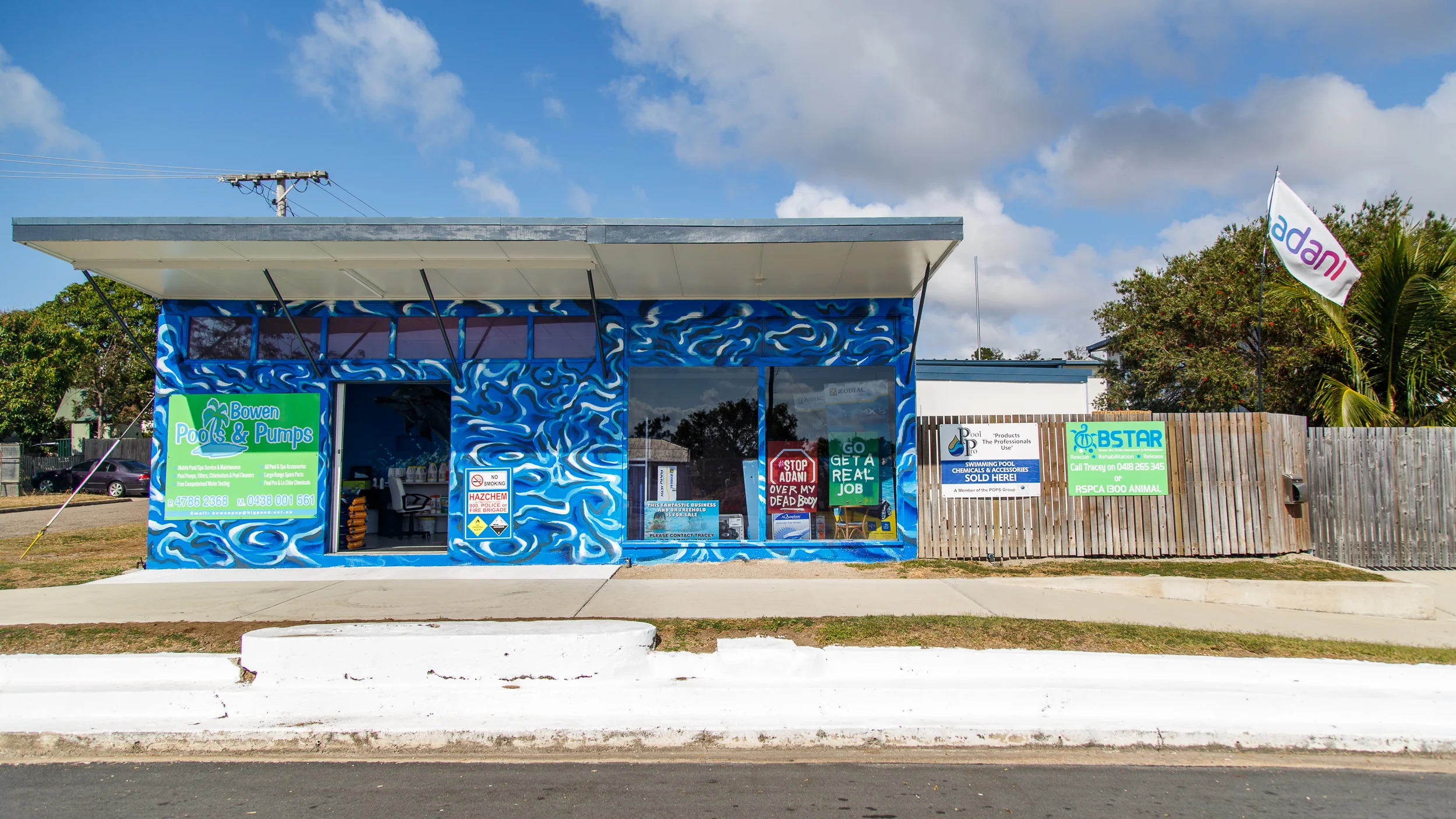 Locals feel the Adani mine is a light at the end of the tunnel for their depressed mining town. This Pool and Pump shop proudly display their commitment to ensuring the mine goes ahead. 