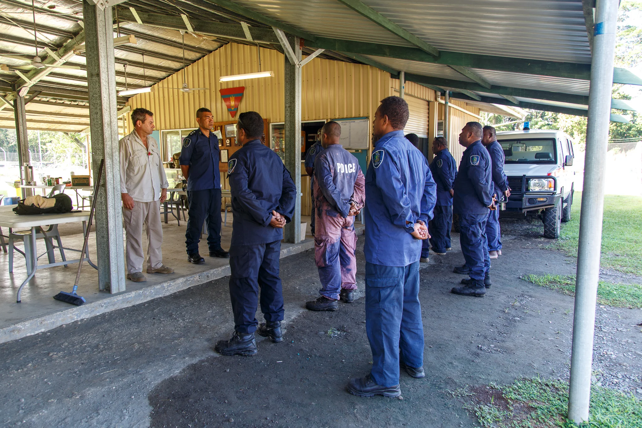  Every morning the Royal Solomon Islander Police Force Explosive Disposal Team receive their daily orders from Golden West Project Manager Paul Eldred and Sergeant Clifford Tunuki. The Explosive Disposal Team are the only group qualified in explosive