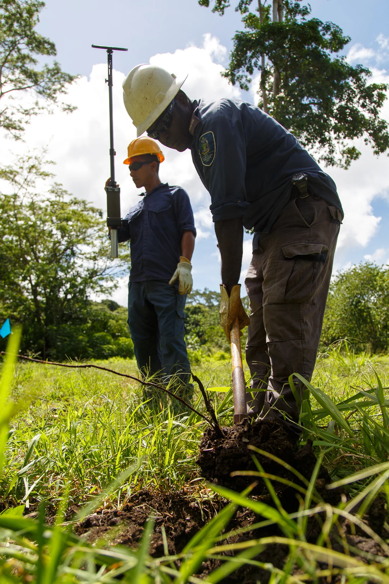 Police Constables Reinhard Alalo and Armstrong Ragoso slowly clear site 15 at Hell’s Point detonation range in Honiara. The team members use the clearance around this area as training when they are out in the community responding to locals who have 