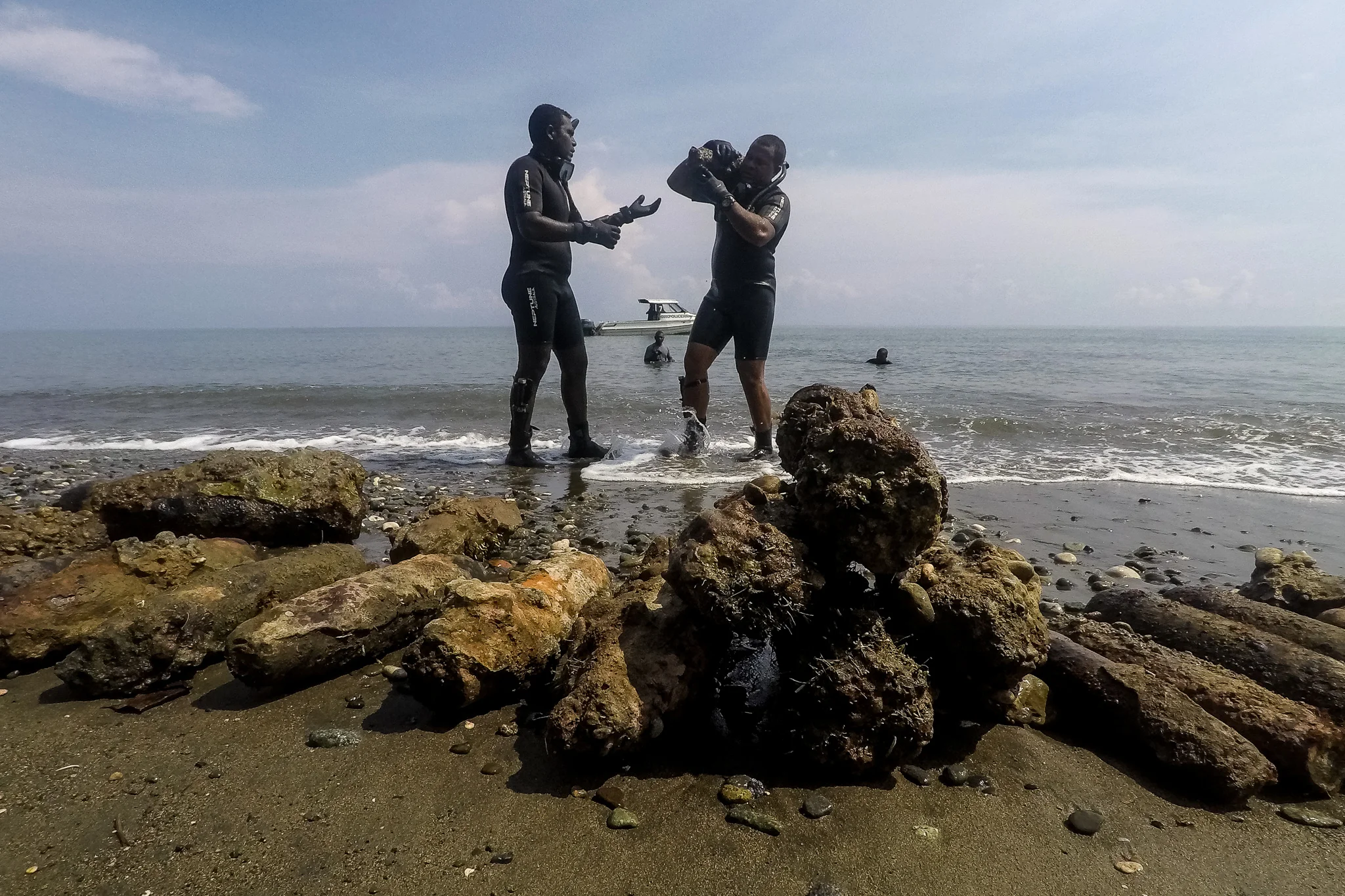  Police Constable Armstrong Ragoso and Sergeant Simon Rihia share the task of hauling out UXO from the shores of Alligator Creek in Honiara. The dive crew found a sunken barge carrying 35 high explosive projectiles ranging from 75mm up to 150mm in wa