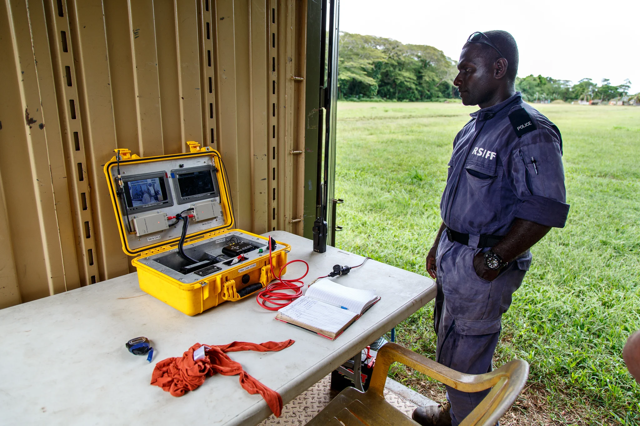  Police Constable Peter Ririvere watches from a remote shed as a US 75mm projectile is precisely sawn open using an automated cutting tool at Hells Point Detonation Range in Honiara. The projectiles are cut open in order to properly dispose of the UX