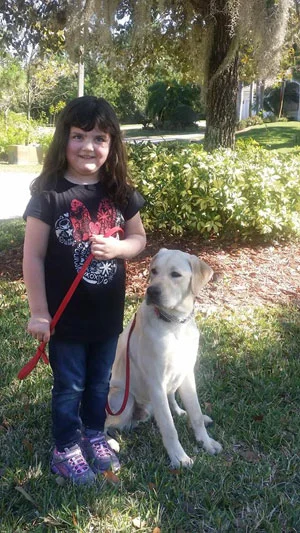 Kayleigh is all smiles with her service dog, Thaddeus.