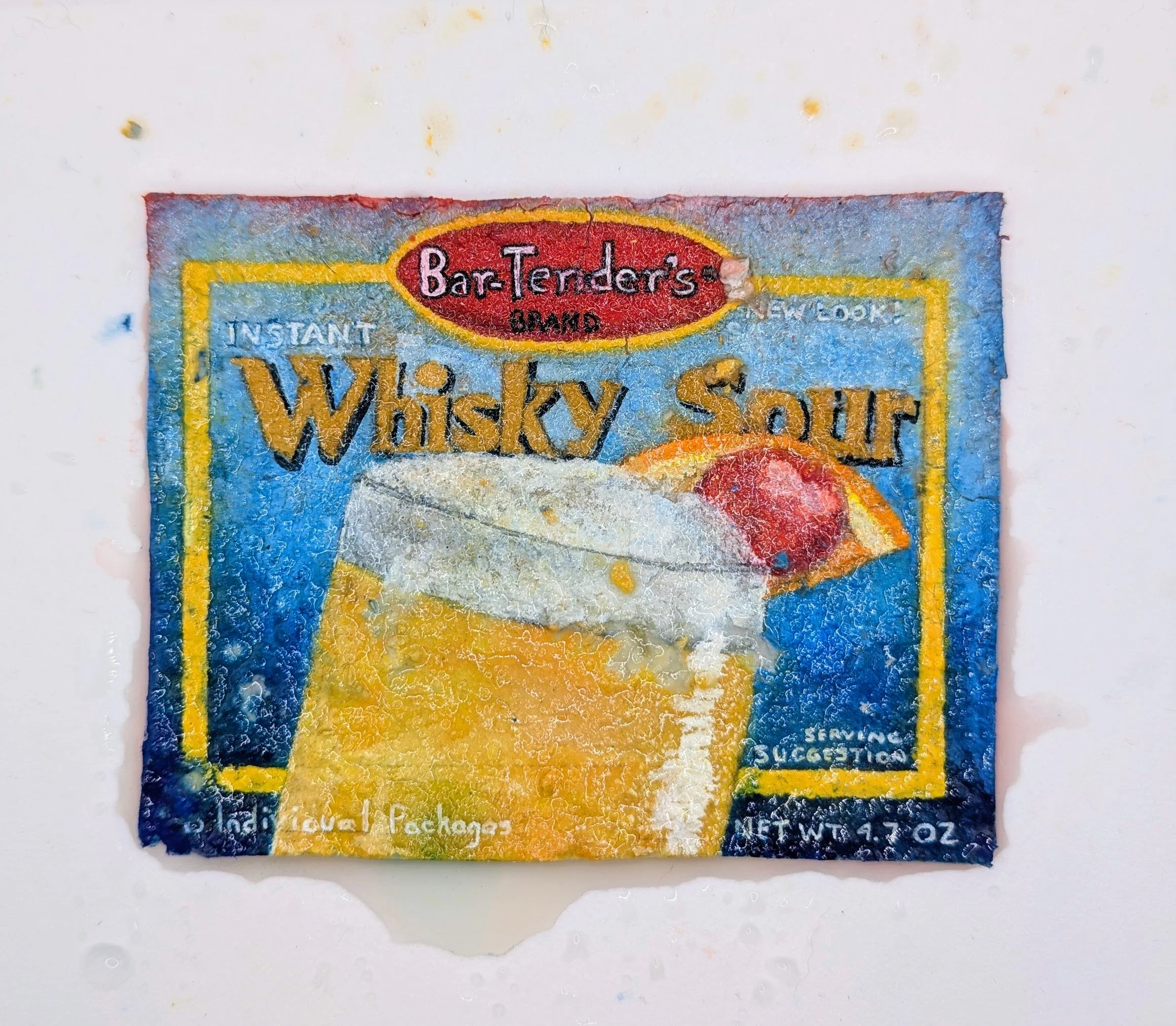 A paper seed bomb painted to look like a package of whiskey sour mix