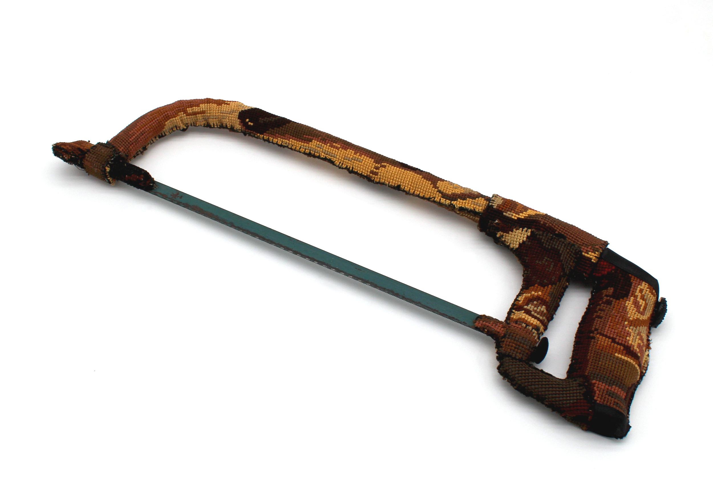 A hacksaw upholstered in a vintage tapestry