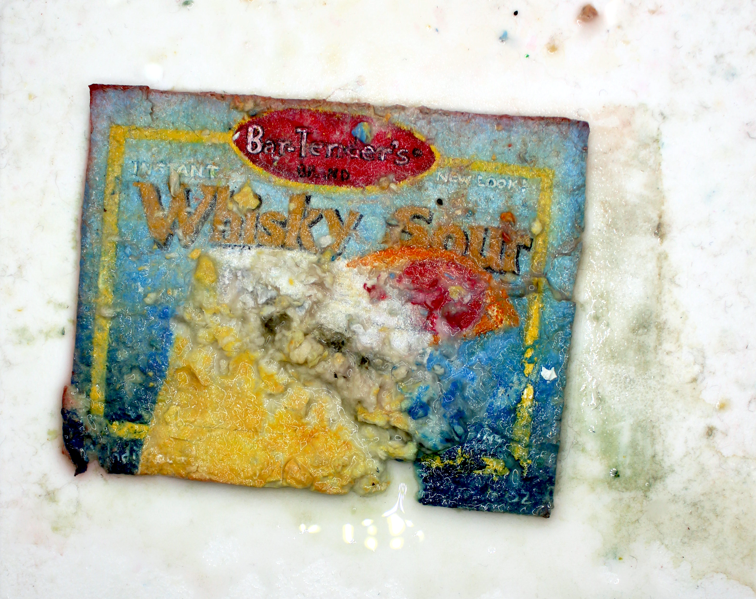 A weathered and partially torn vintage wrapper of a product branded as 'Bar-Lemon's' on a white surface.