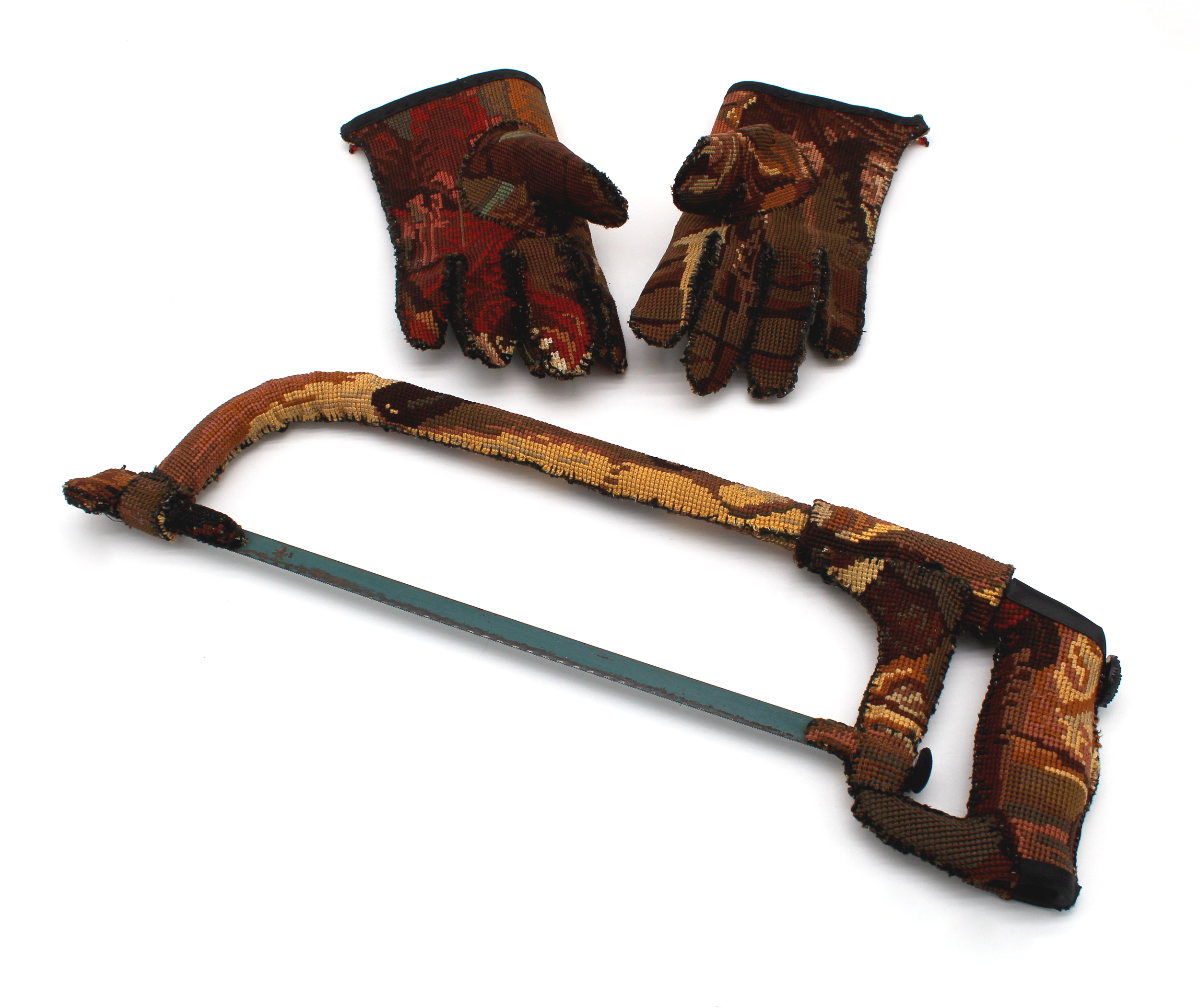 A pair of tapestry gloves and a hacksaw upholstered in the same tapestry fabric