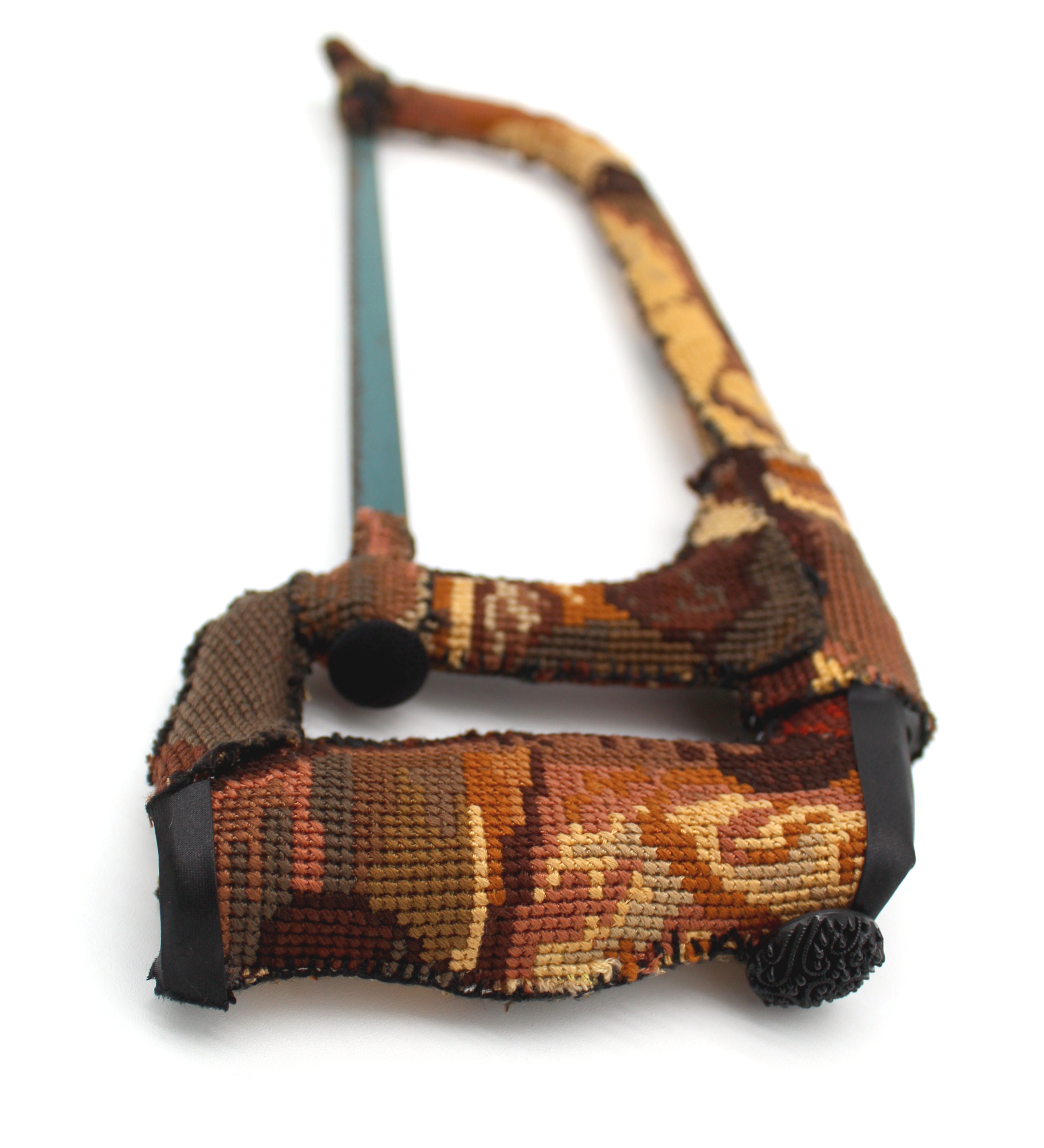 a hacksaw upholstered in a vintage tapestry