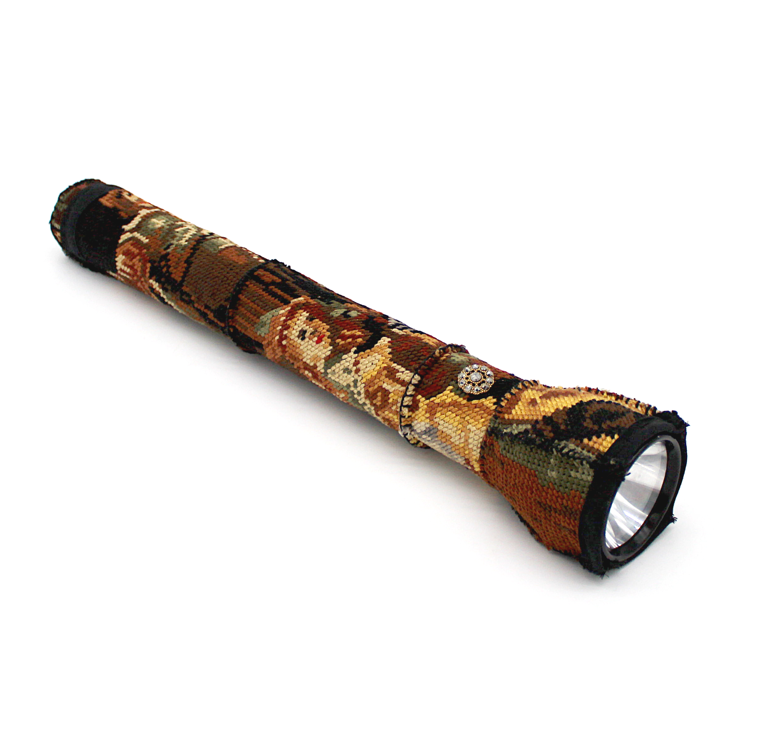 A large vintage maglite flashlight covered in cross-stitch of the Rembrandt painting The Night Watch