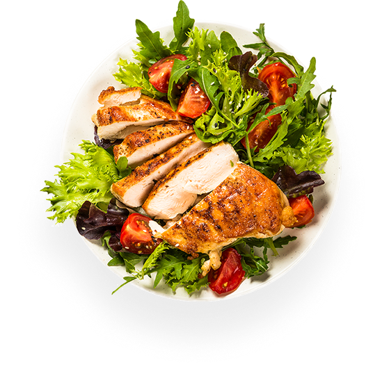 Grilled chicken breast on salad with cherry tomatoes and mixed greens