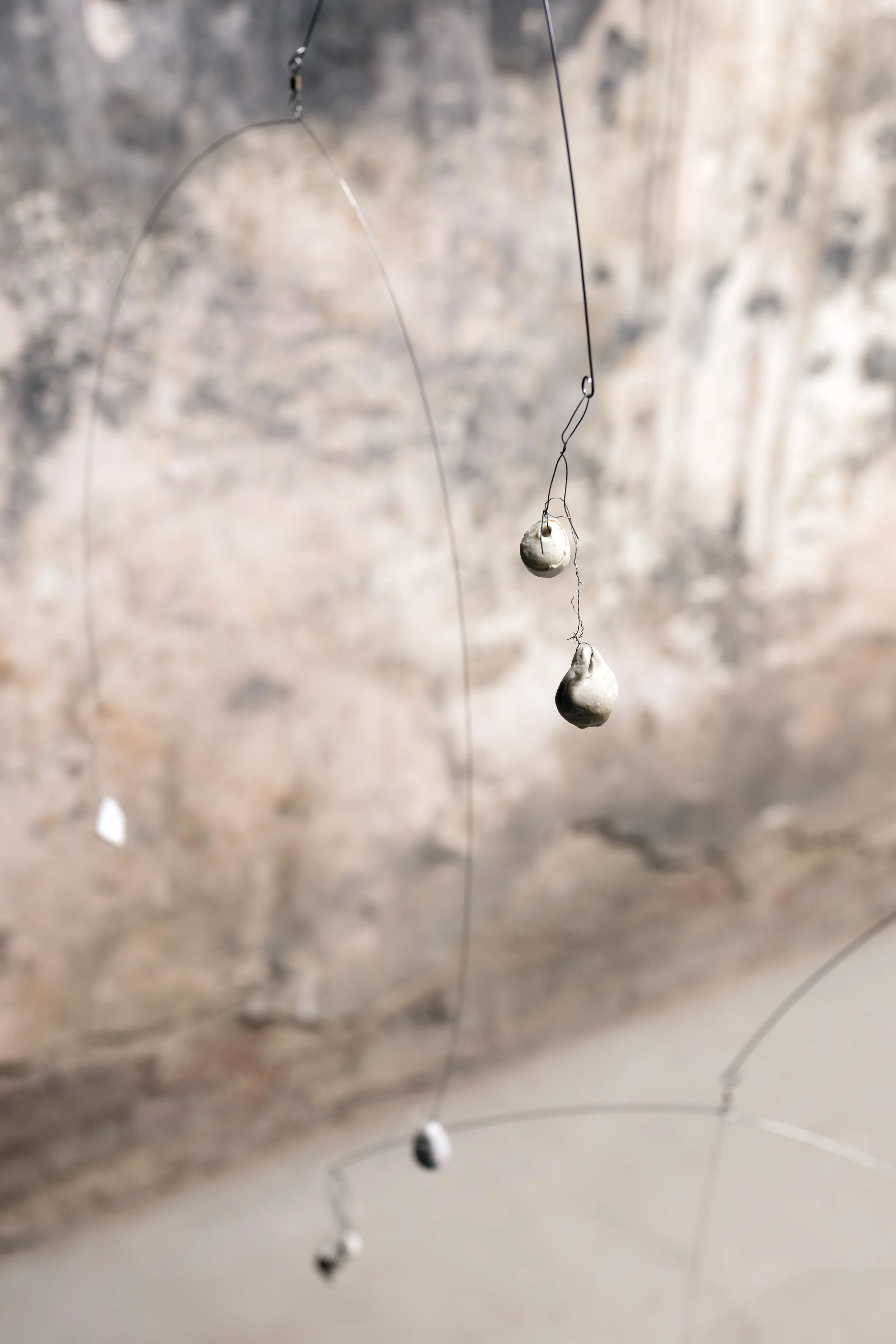 Bell tongues, a pewter inside, bronze feet (on making dust), bell ringers, piano wire, fishing swivels, pewter, collectible bell, bronze casts of the insides of my shoes, fossil dust, birch ply, middle gray paint, 2018 (detail)