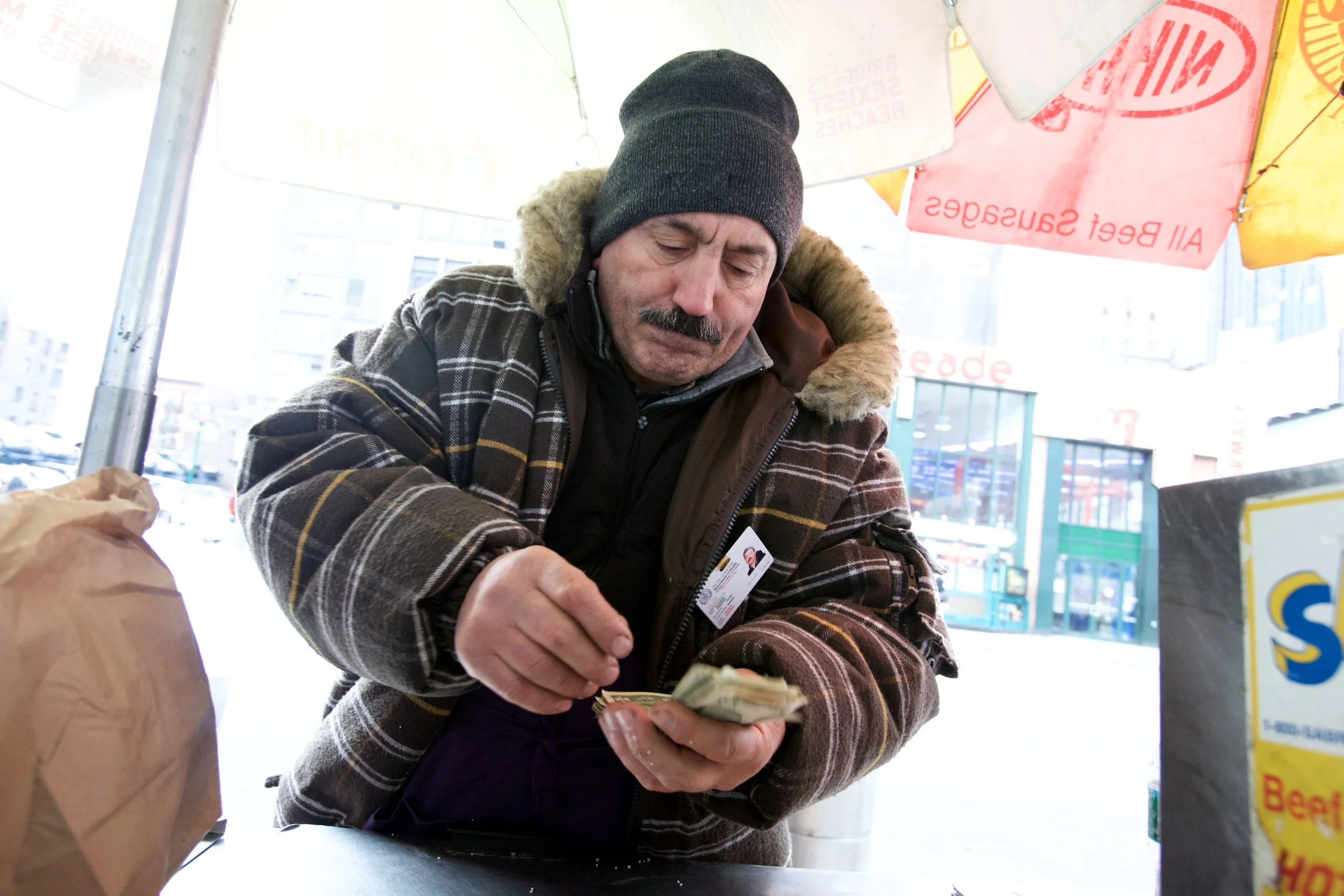 STREET VENDOR COUNTING THE CHANGE