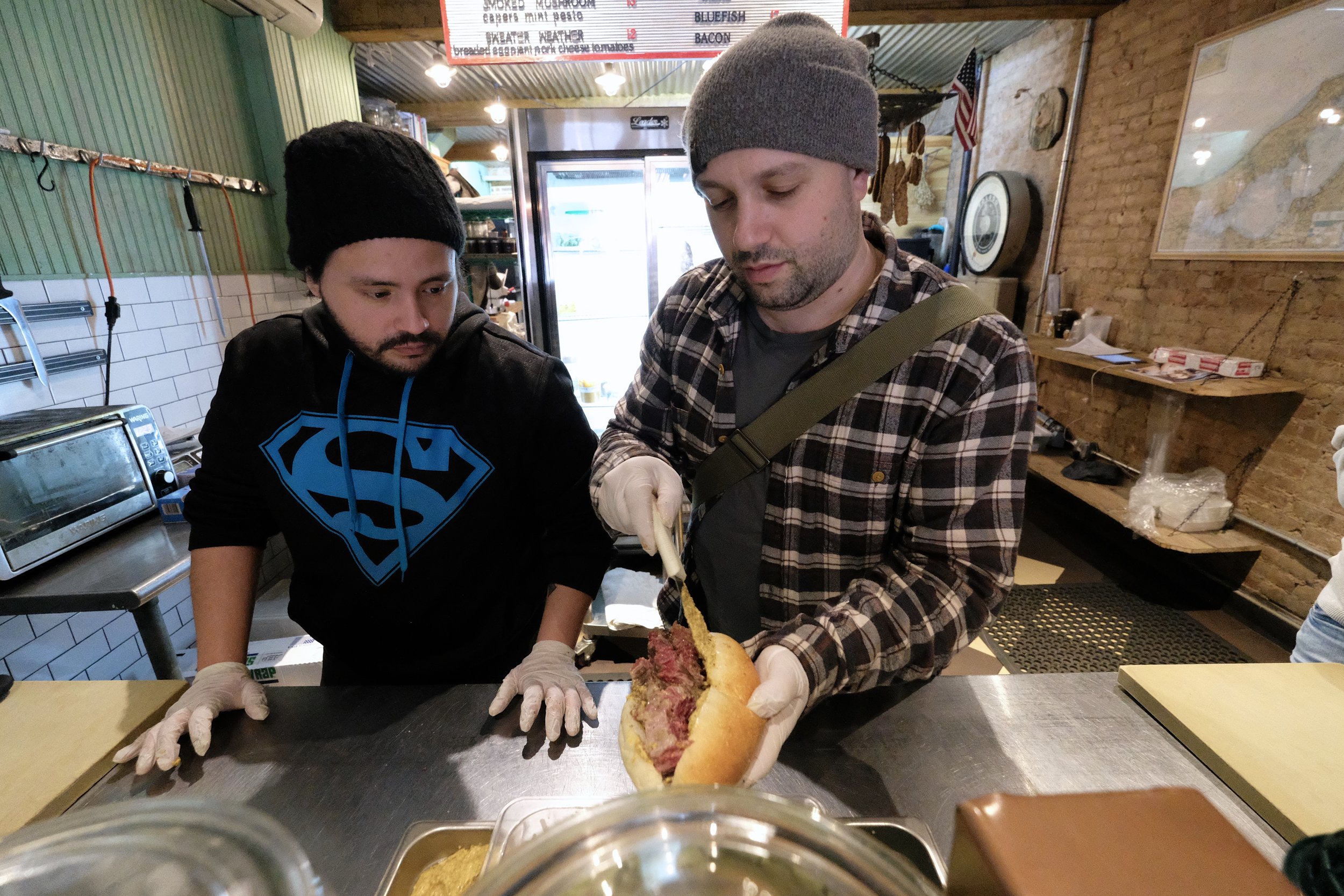 Will Horowitz prepares my "Pop's Pastrami" sandwich.