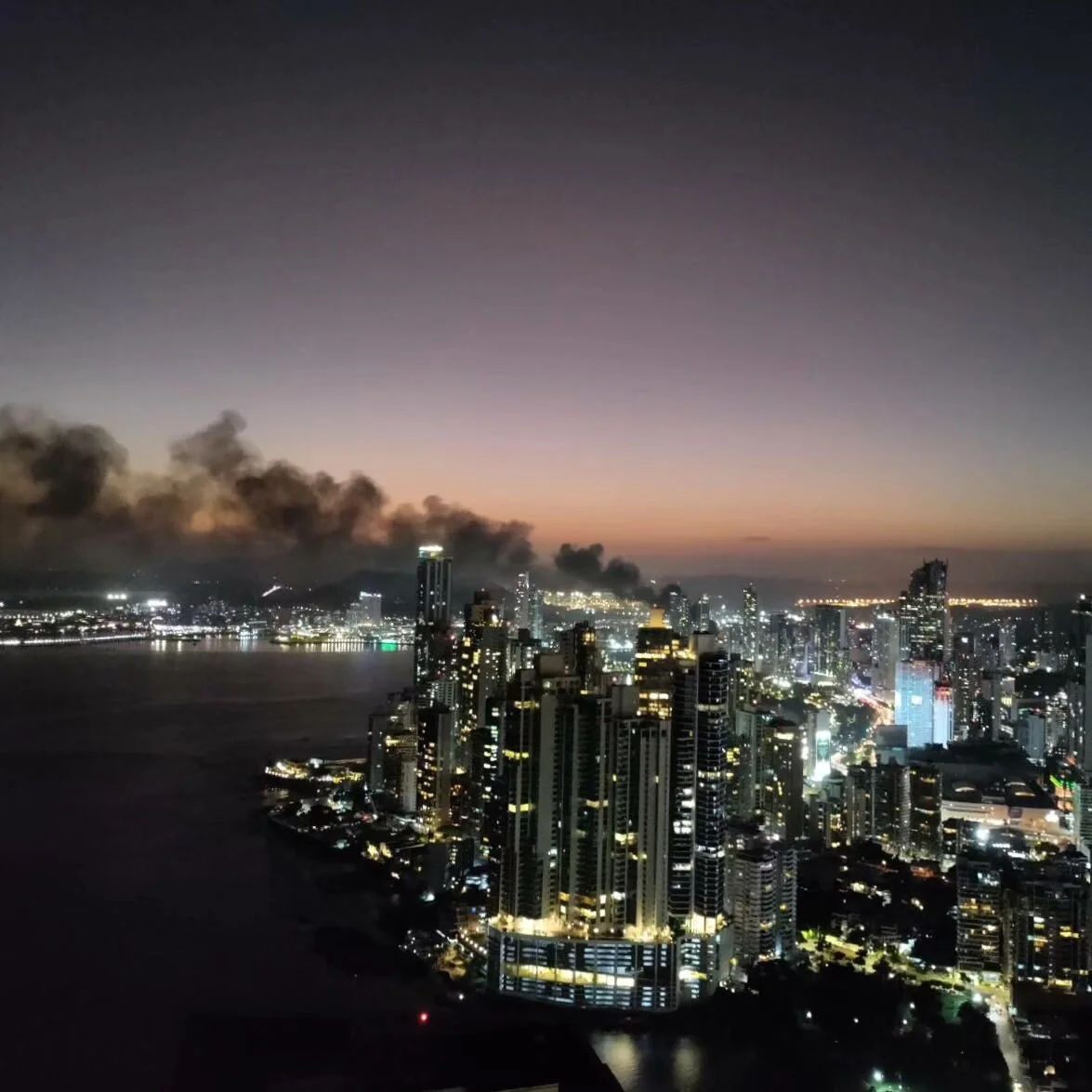 The sky quickly ripened from rose and gold to bruised blue. Beneath the beauty, life. Panama arrived with now familiar border bustle plus added reality. Birds roosted, squabbling in discord below tin sunshades. Bats wheeled, parting lamplit bug cloud