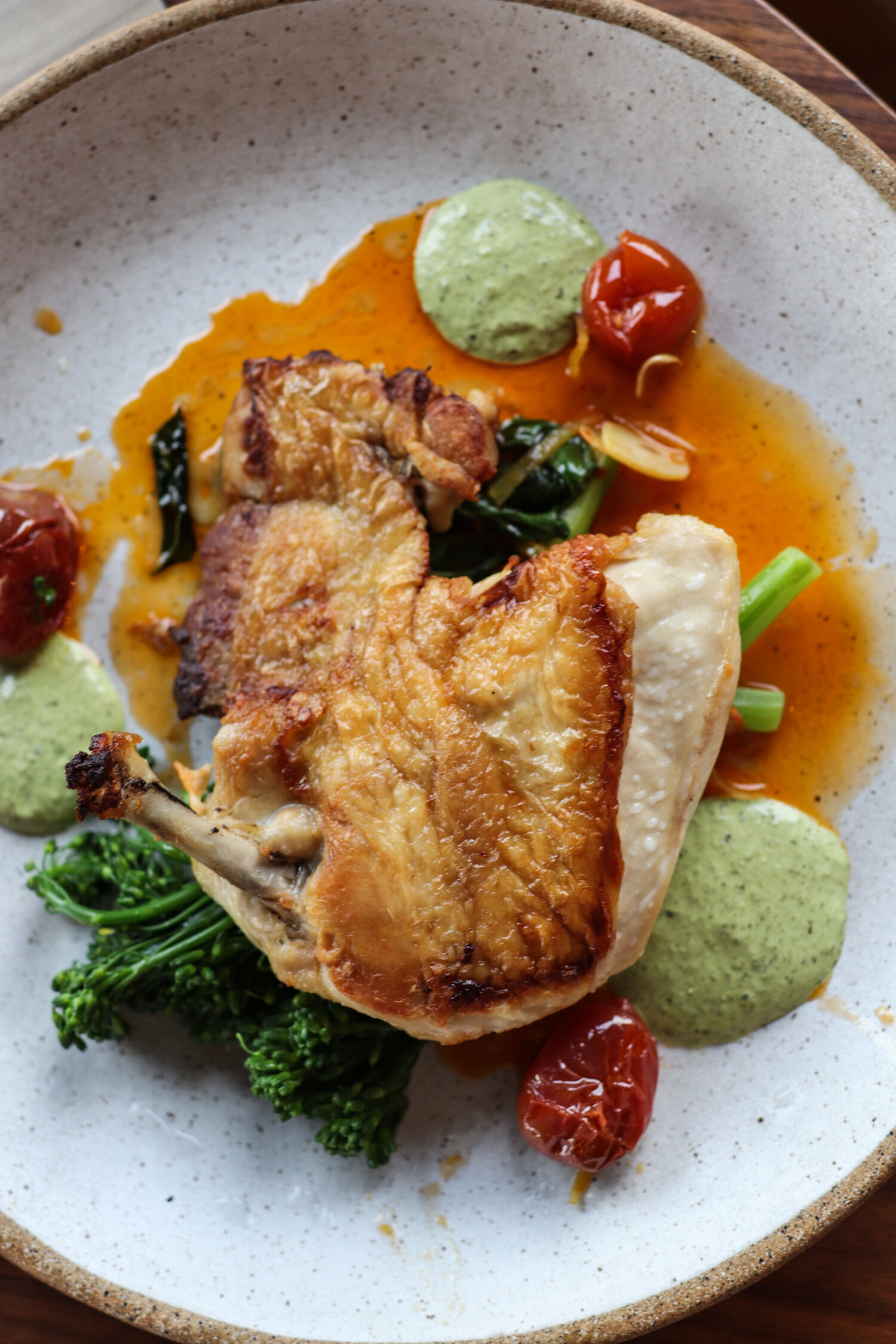 Brick chicken finished in the Marra Forni with blistered tomatoes, broccolini, and creamy salsa verde that played like fresh green goddess dressing.