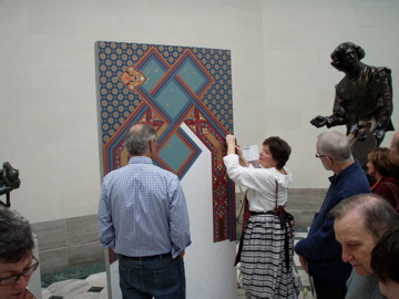Heidi demonstrating the application of Bradbury wallpaper for the Legion of Honor presentation. 
