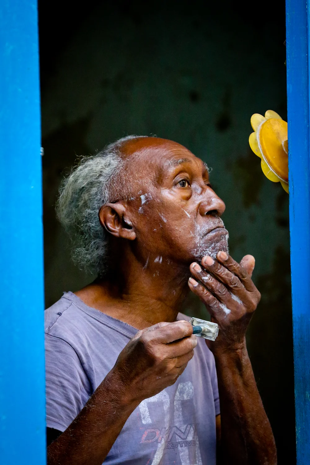 Life in Cuba is visible. People have their doors and windows open much of the time (few have A/C) and so you can see a lot of everyday happenings. This beautiful old guy in Havana was doing his best to get a close shave, on the little mirror next to his front door. 