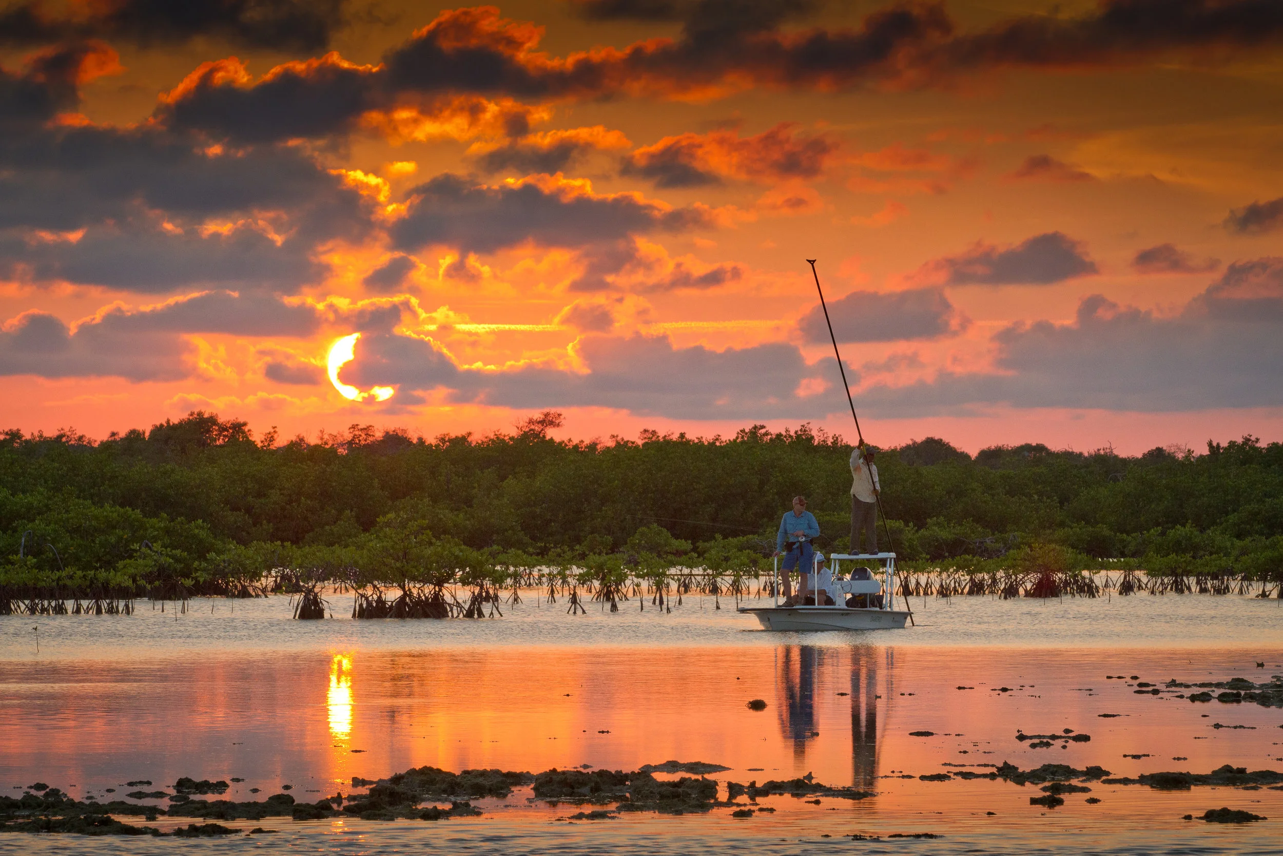 Guide poles guests over a Bonefish flat at last light-Jardines de la Reina, Cuba
