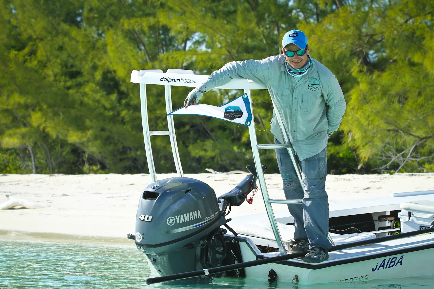 Espin proudly raises the banner letting other skiffs know a Permit was landed