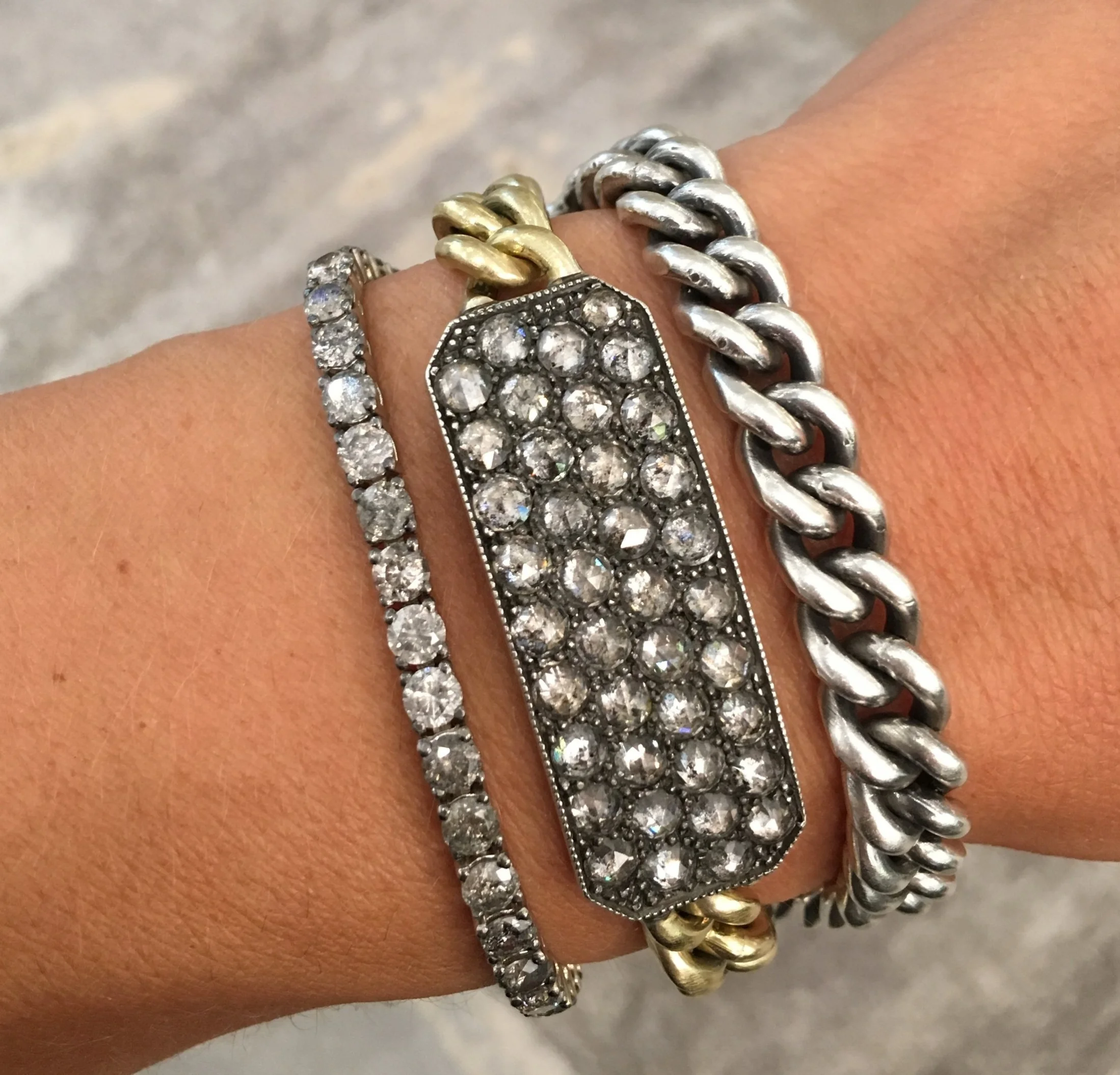 Sylva and Cie Grey Diamond Ten Table Bracelet. 18K yellow gold and silver wrap bracelet features a diamond coated plaque with over 6.7 cts of grey diamonds.