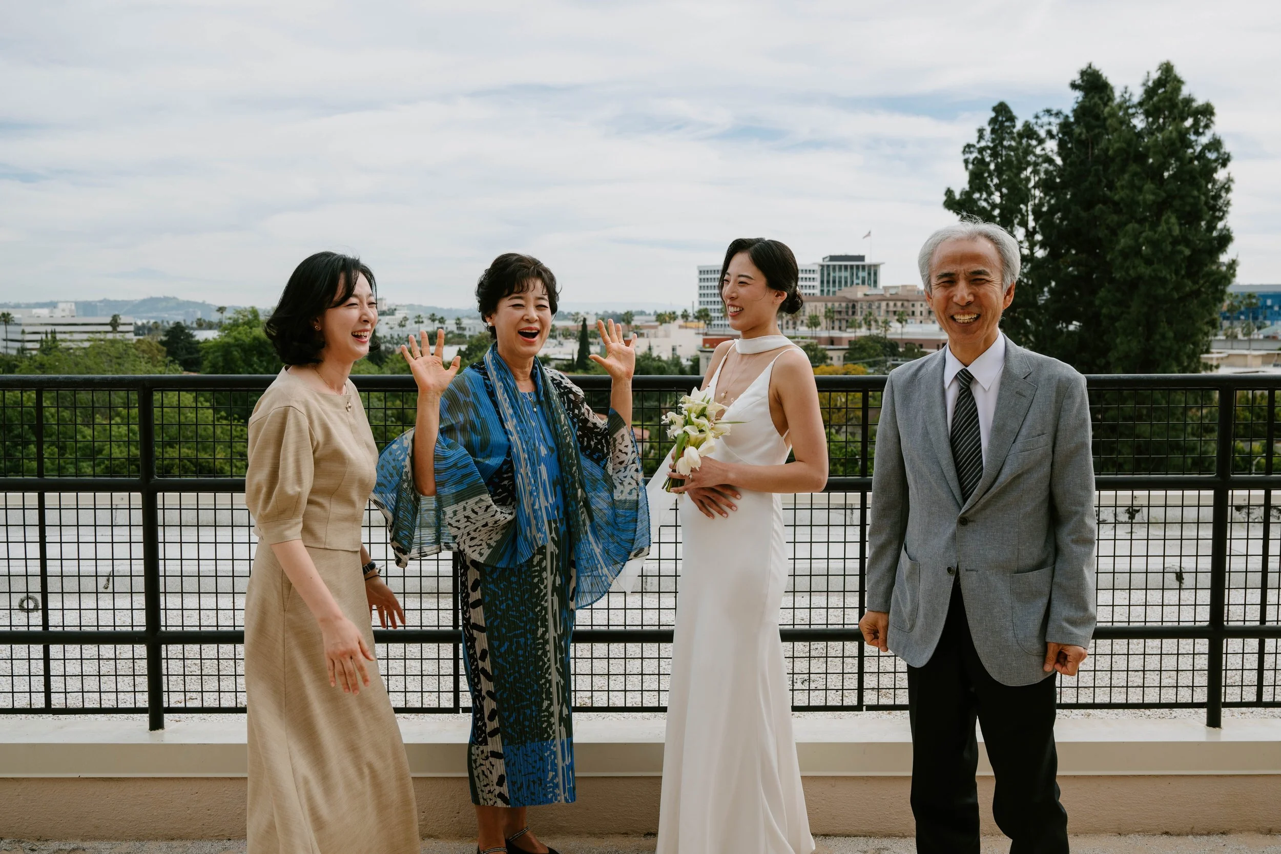 Bride laughing with her family after courthouse wedding ceremony.