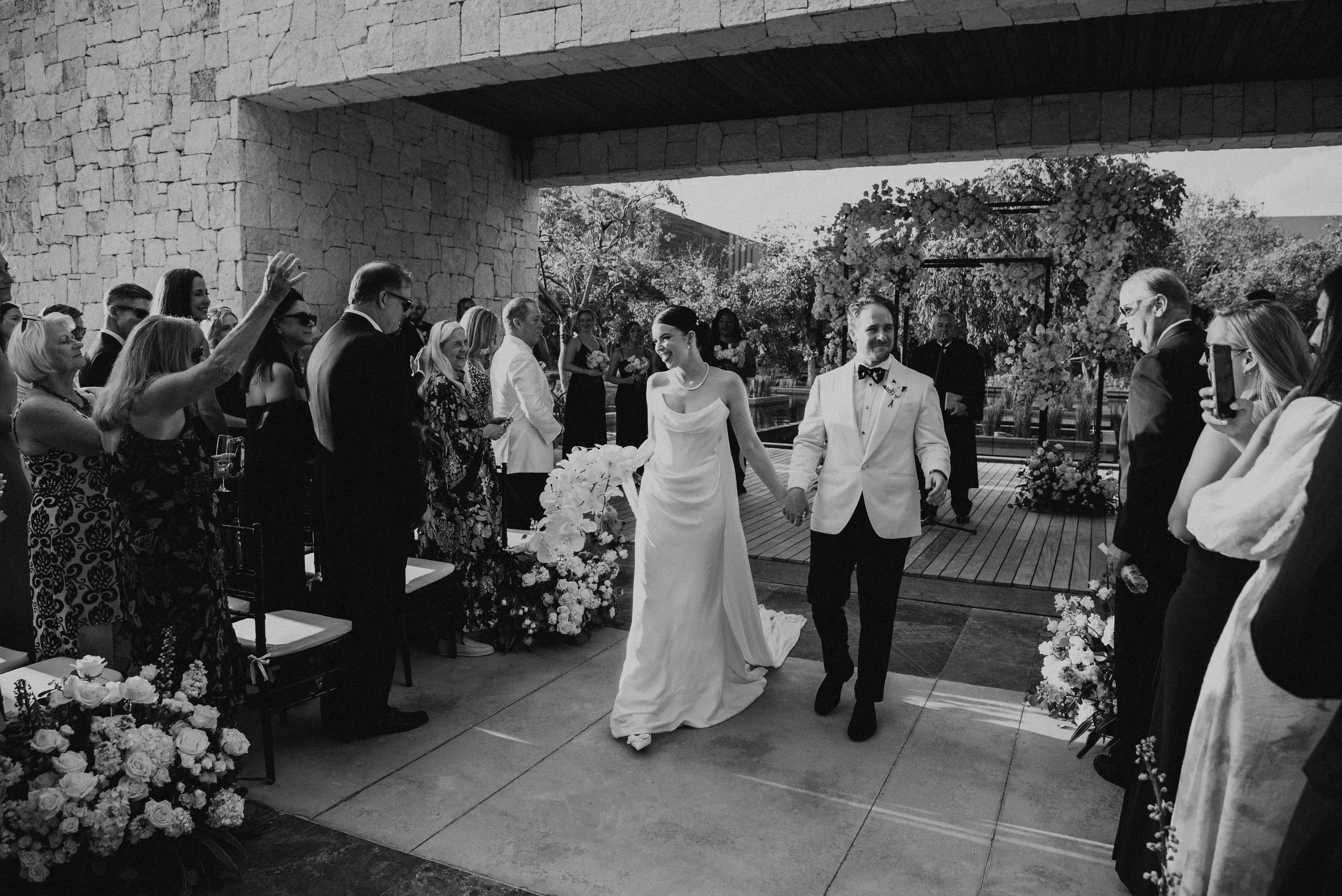black and white photos of bride and groom walking down the aisle after being announced as Mr. & Mrs.