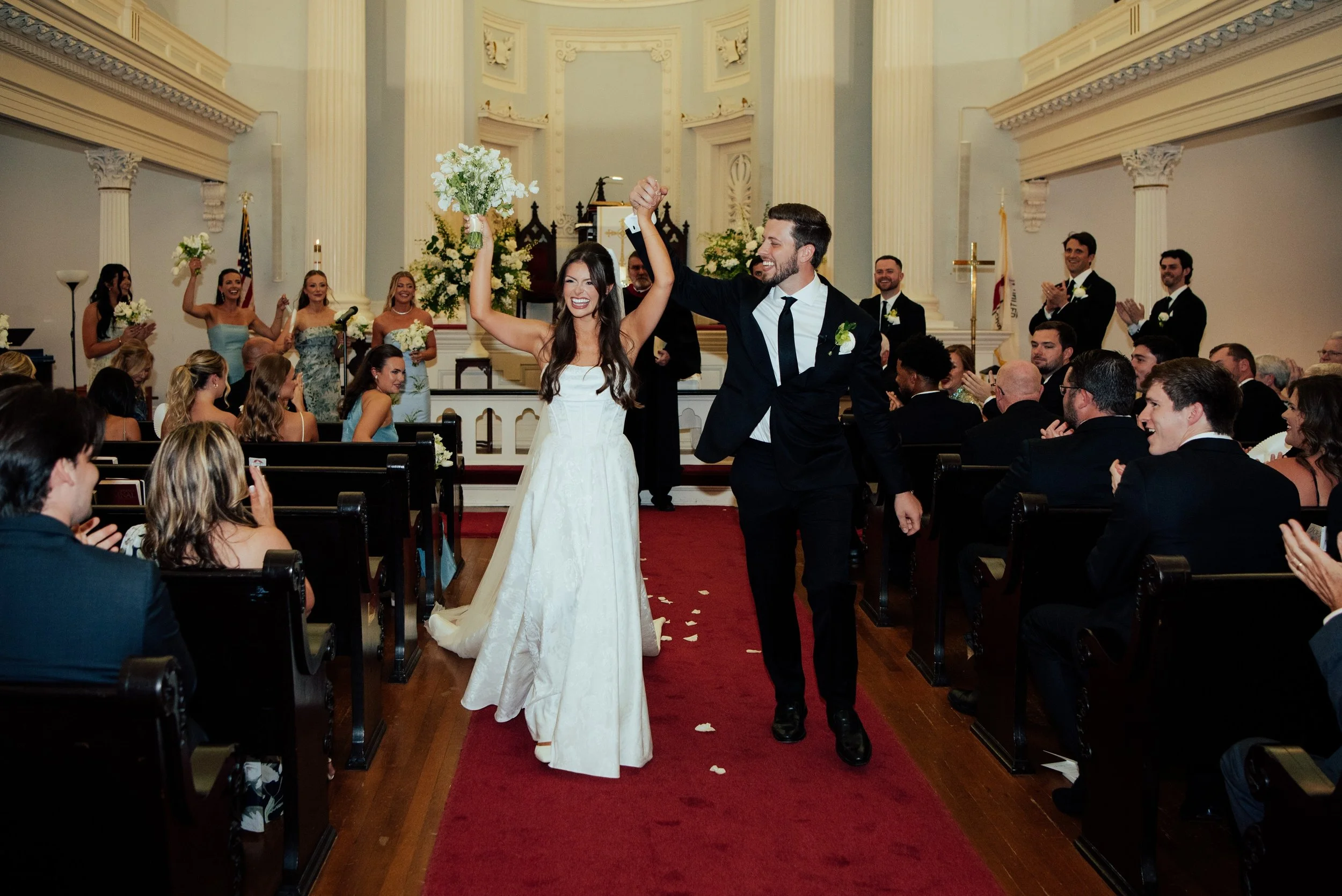 photo of a happy bride and groom walking back down the aisle after their ceremony