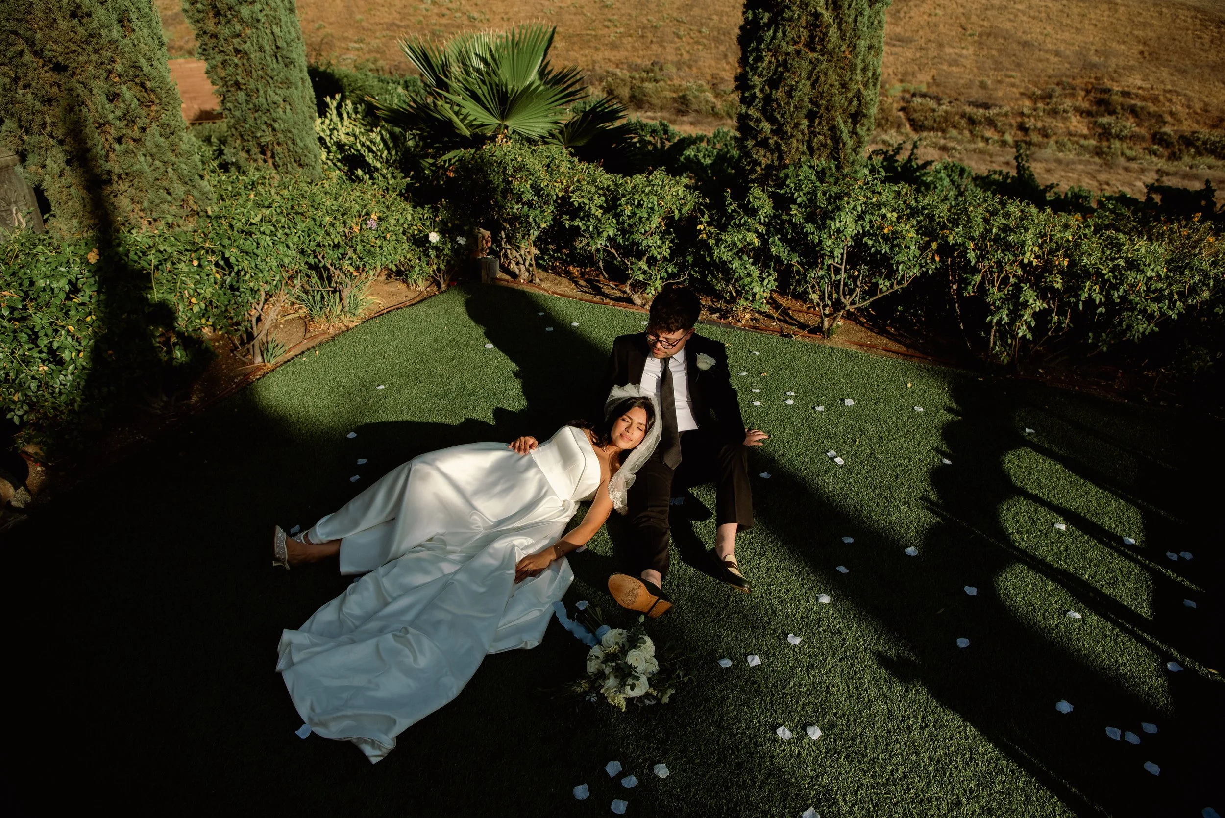 Overhead shot of Bride laying down with her head on grooms leg