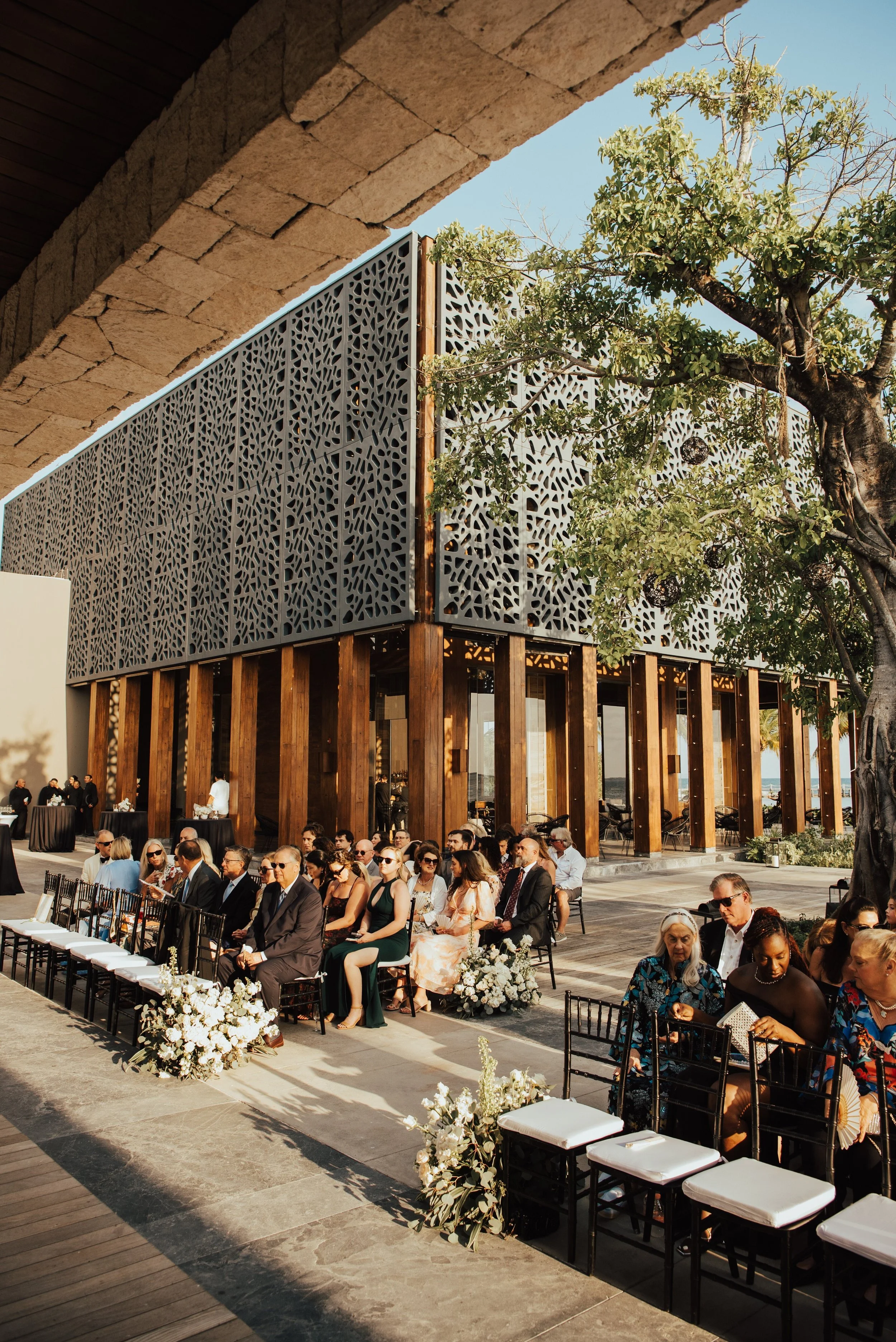 Wide Portrait shot of guest sitting in chairs waiting for ceremony to start
