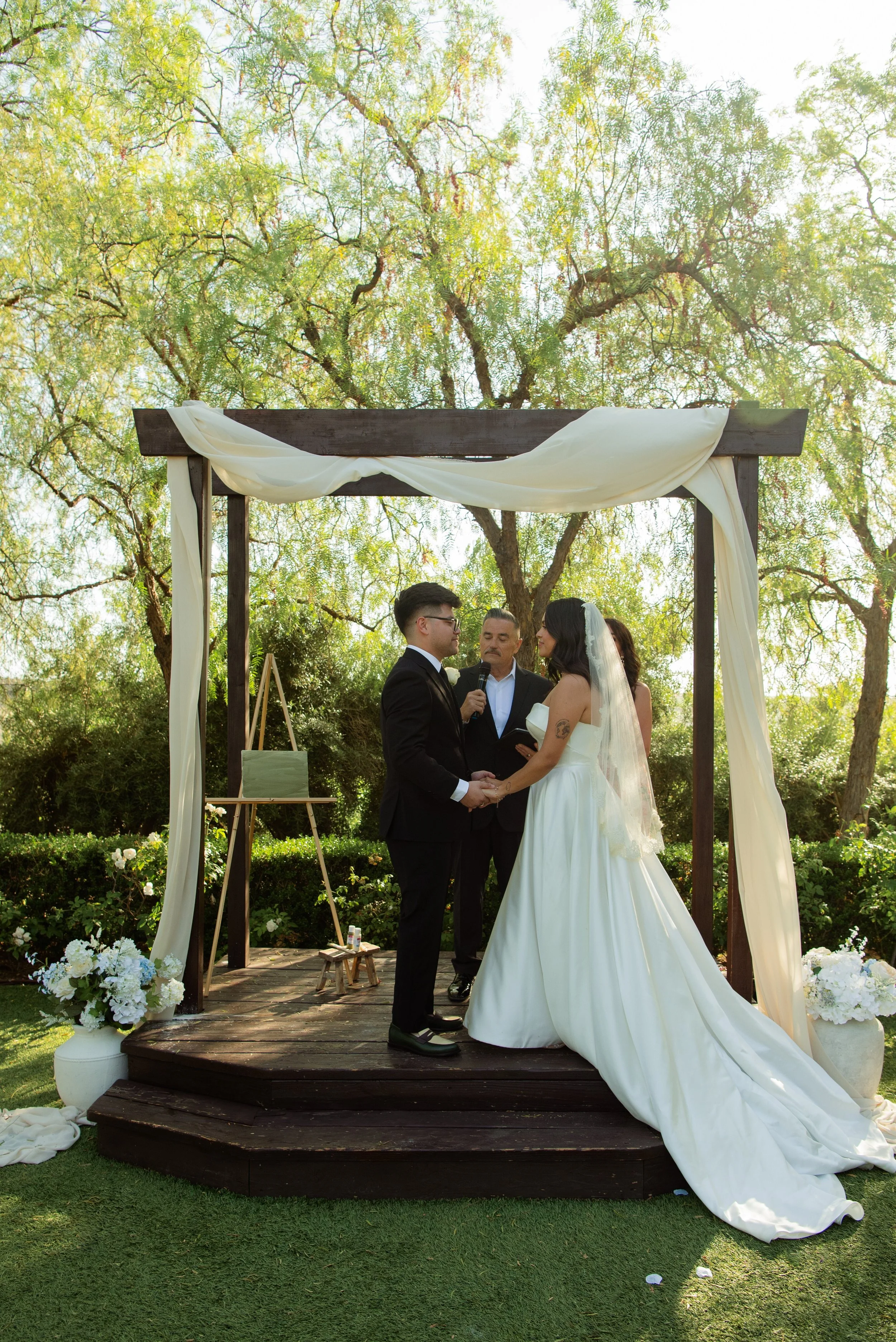 Shot of bride and groom holding hand during their ceremony