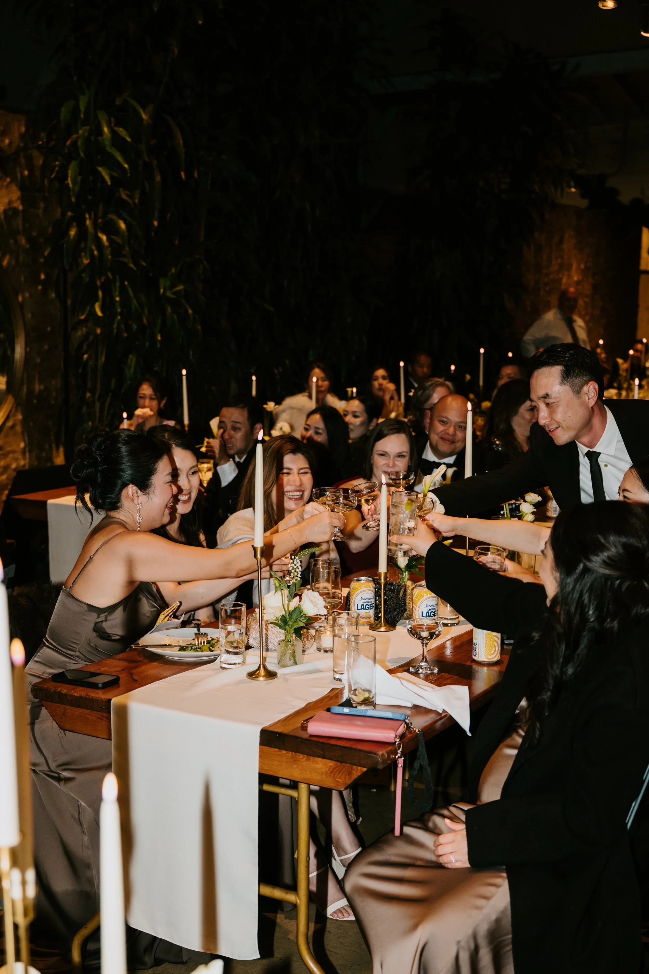 wedding guest cheering their glasses over their table