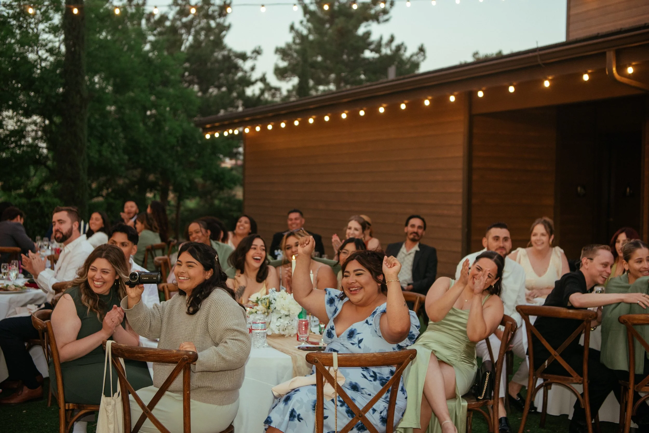 Shot of guest cheering at wedding reception