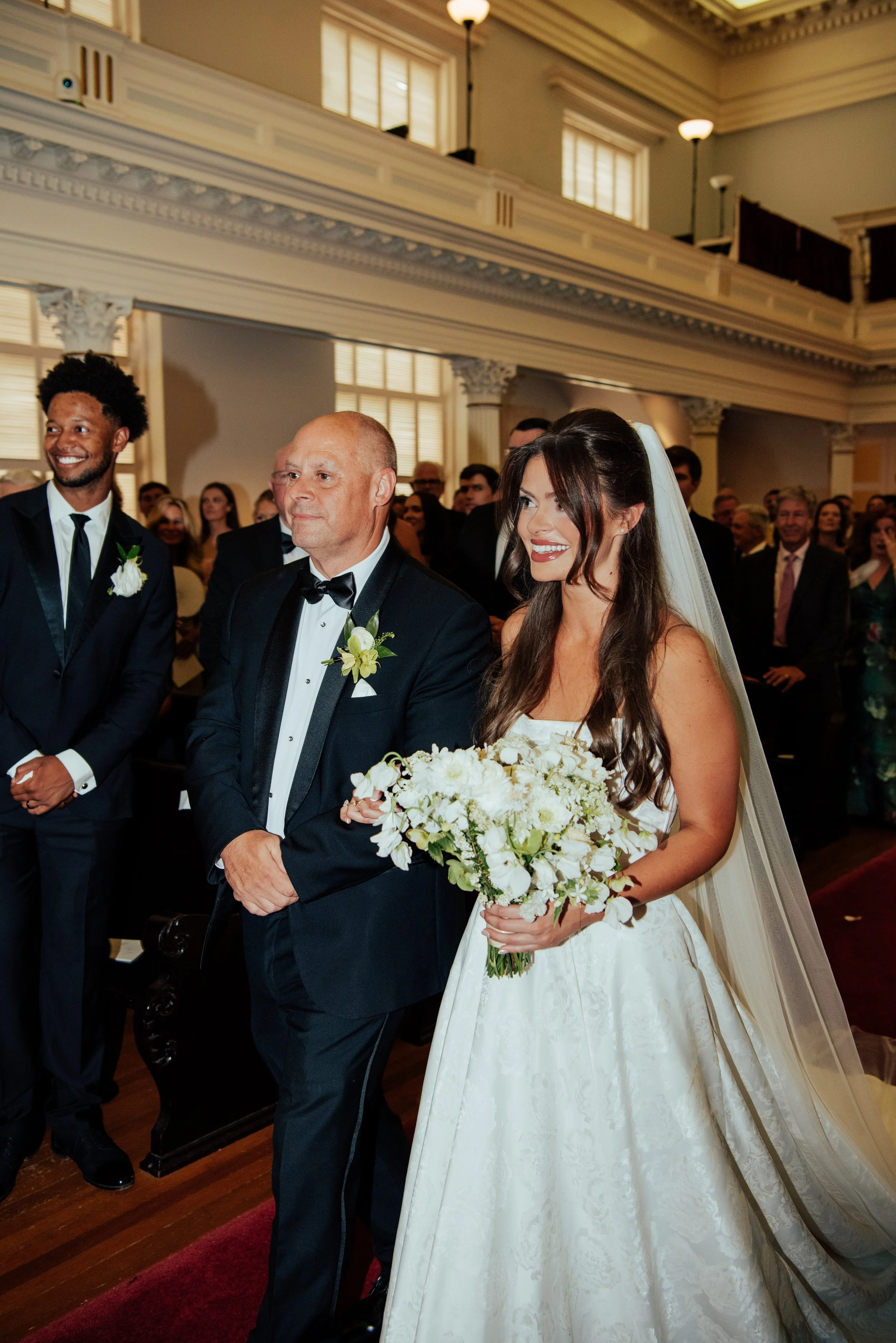 Bride and her father walking down the aisle to her groom