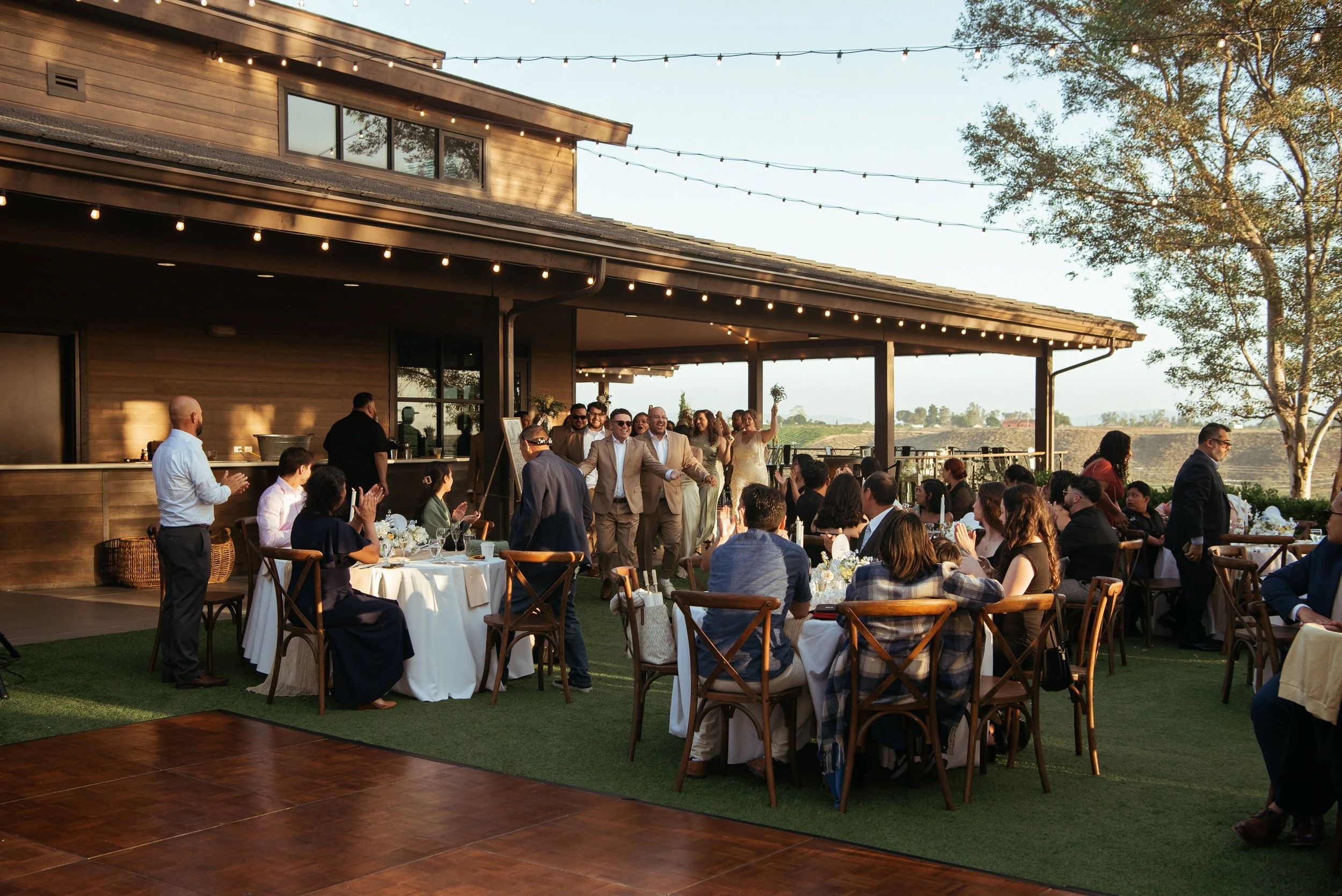 Wide shot of wedding reception as wedding party enters