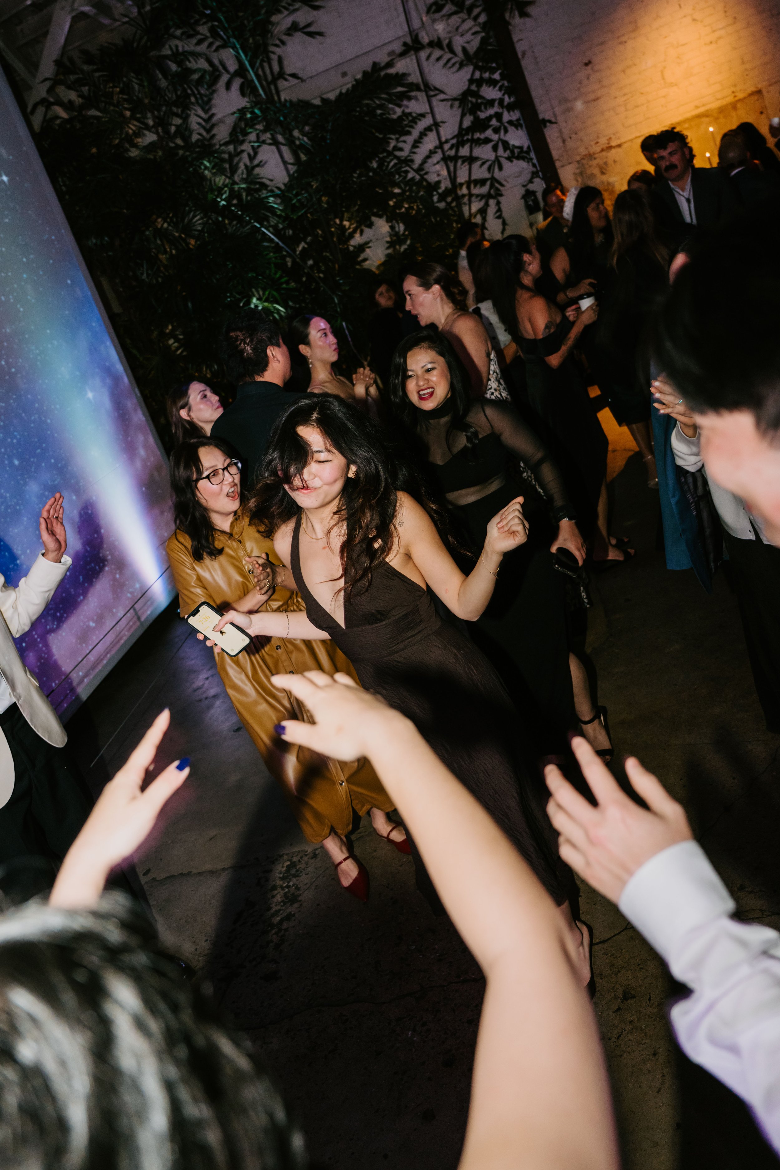 Wedding guest dancing so hard her hair is flying in her face