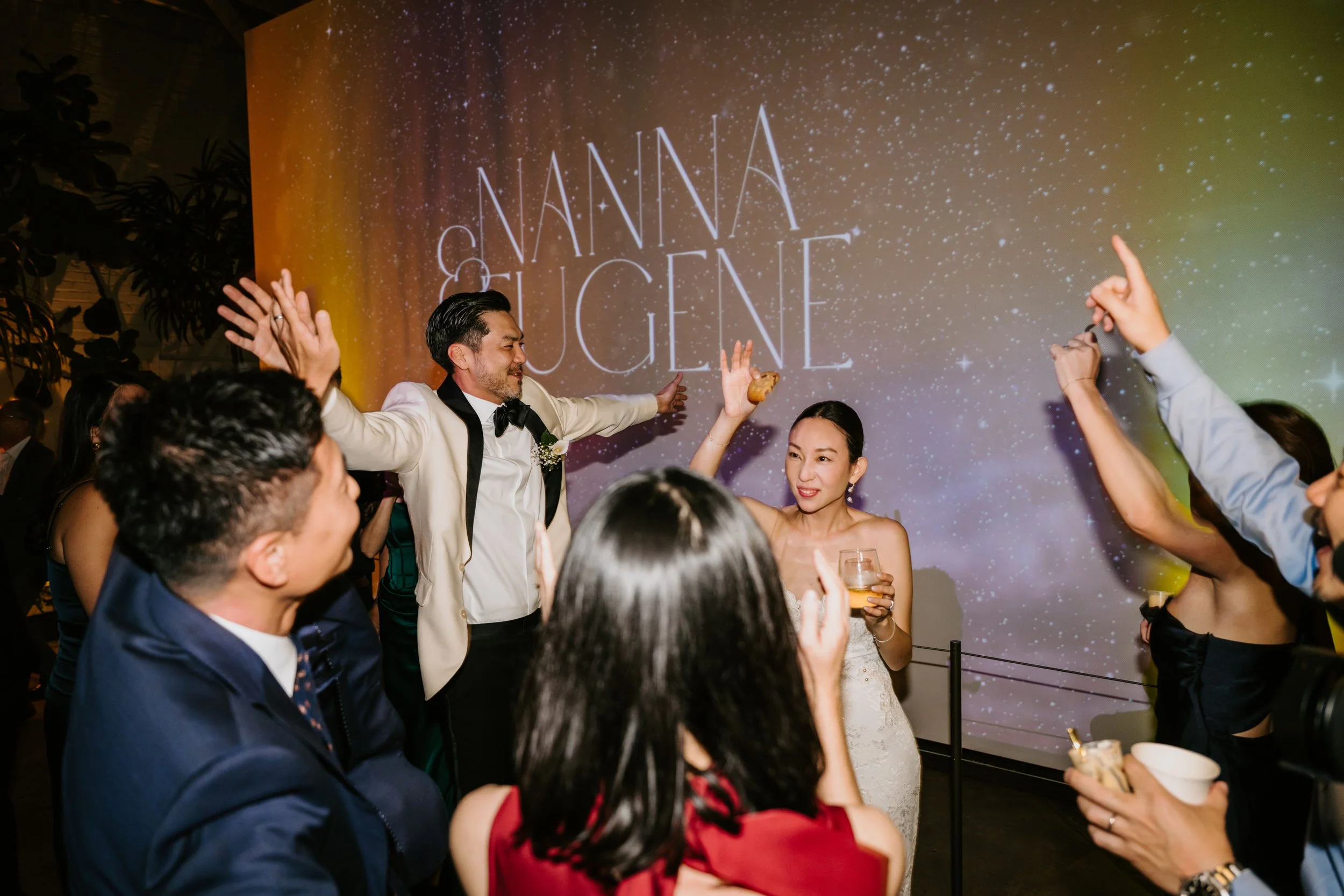 Bride and groom dancing surrounded by guests