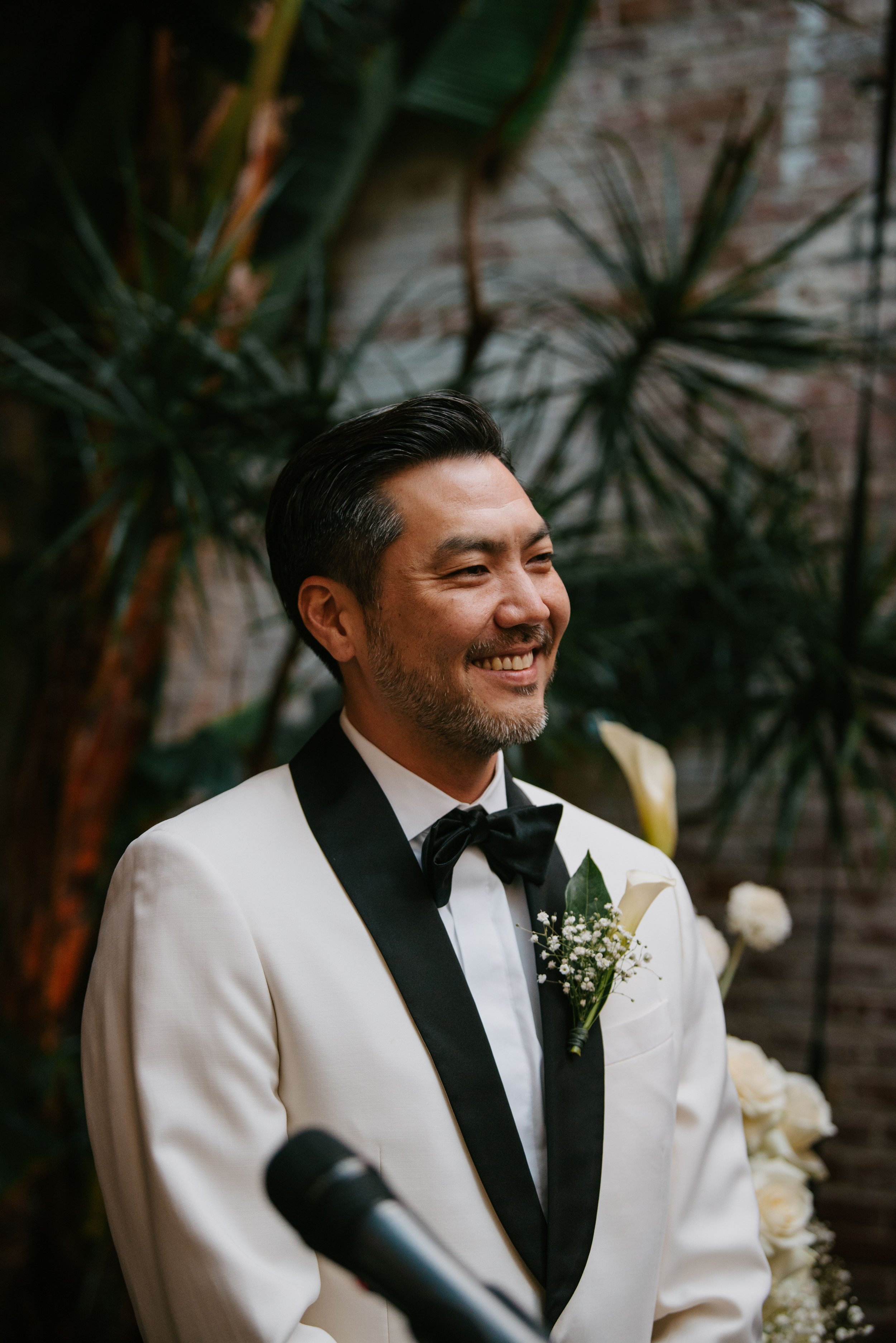 groom smiling waiting for his bride to walk down the aisle