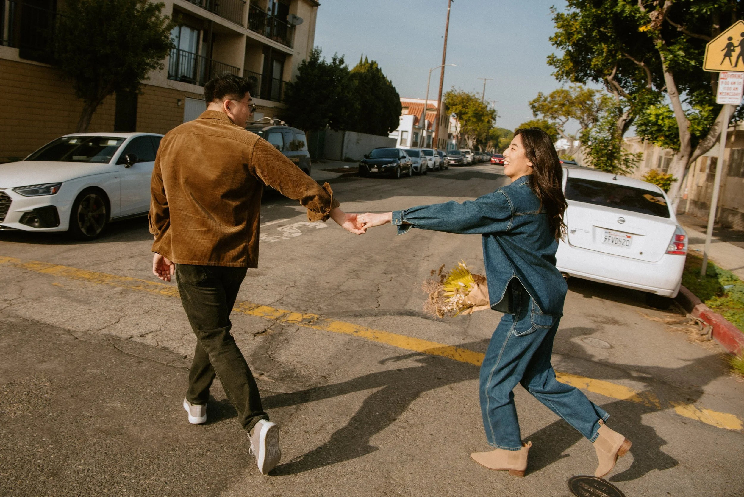 Guy Leading girl as they run across the street