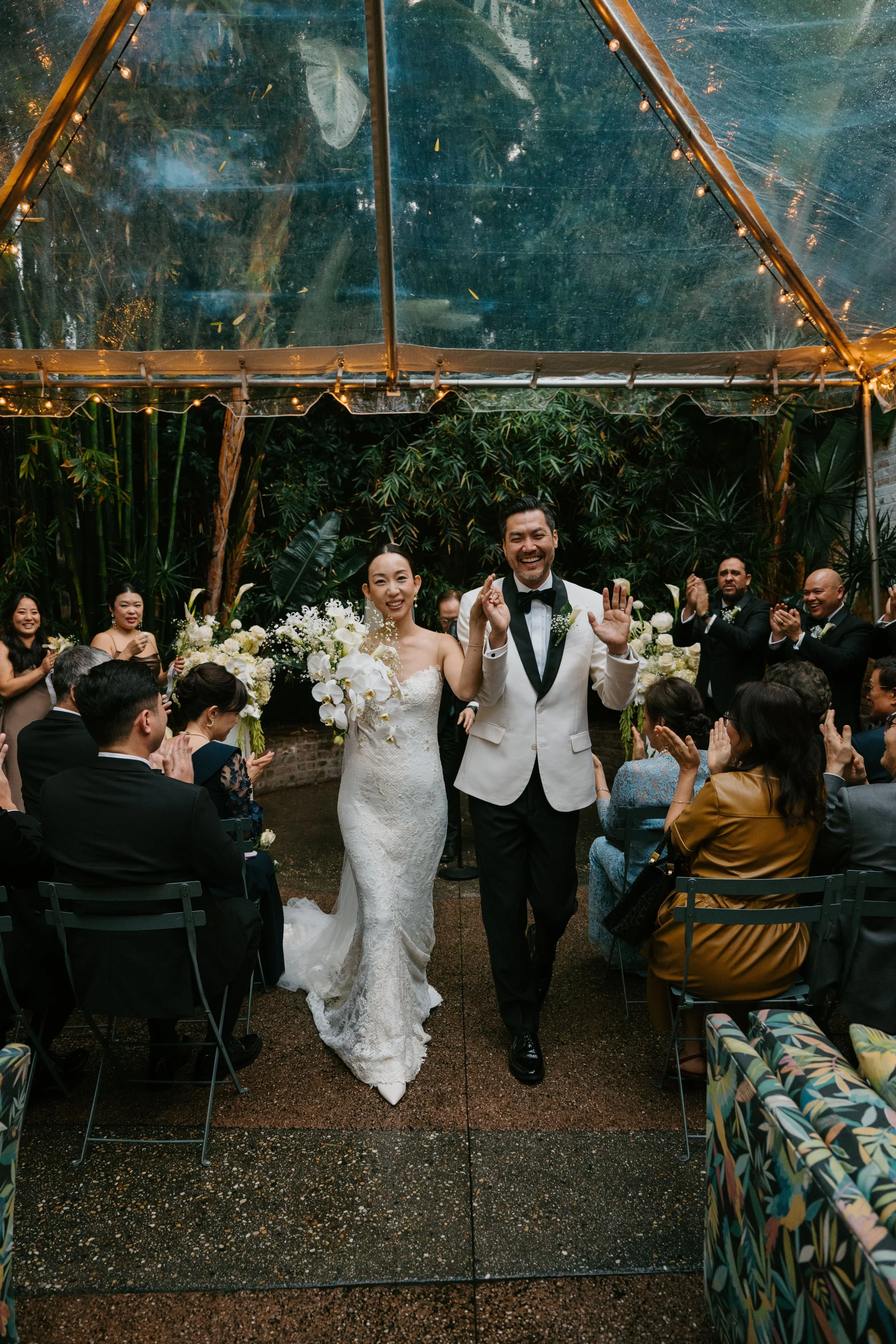 bride and groom smiling as they walk back down the aisle