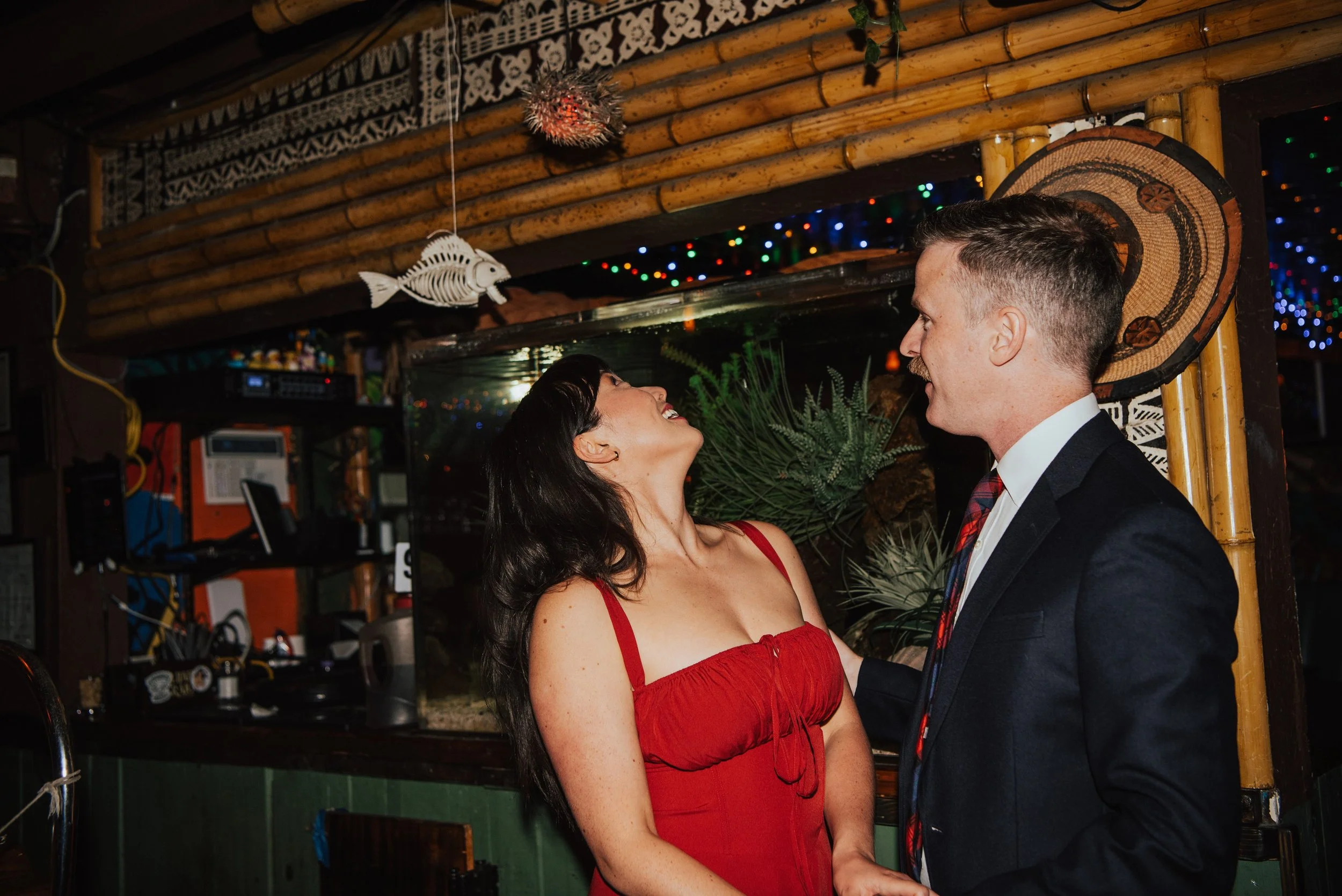 Couple standing in bar as woman looks up