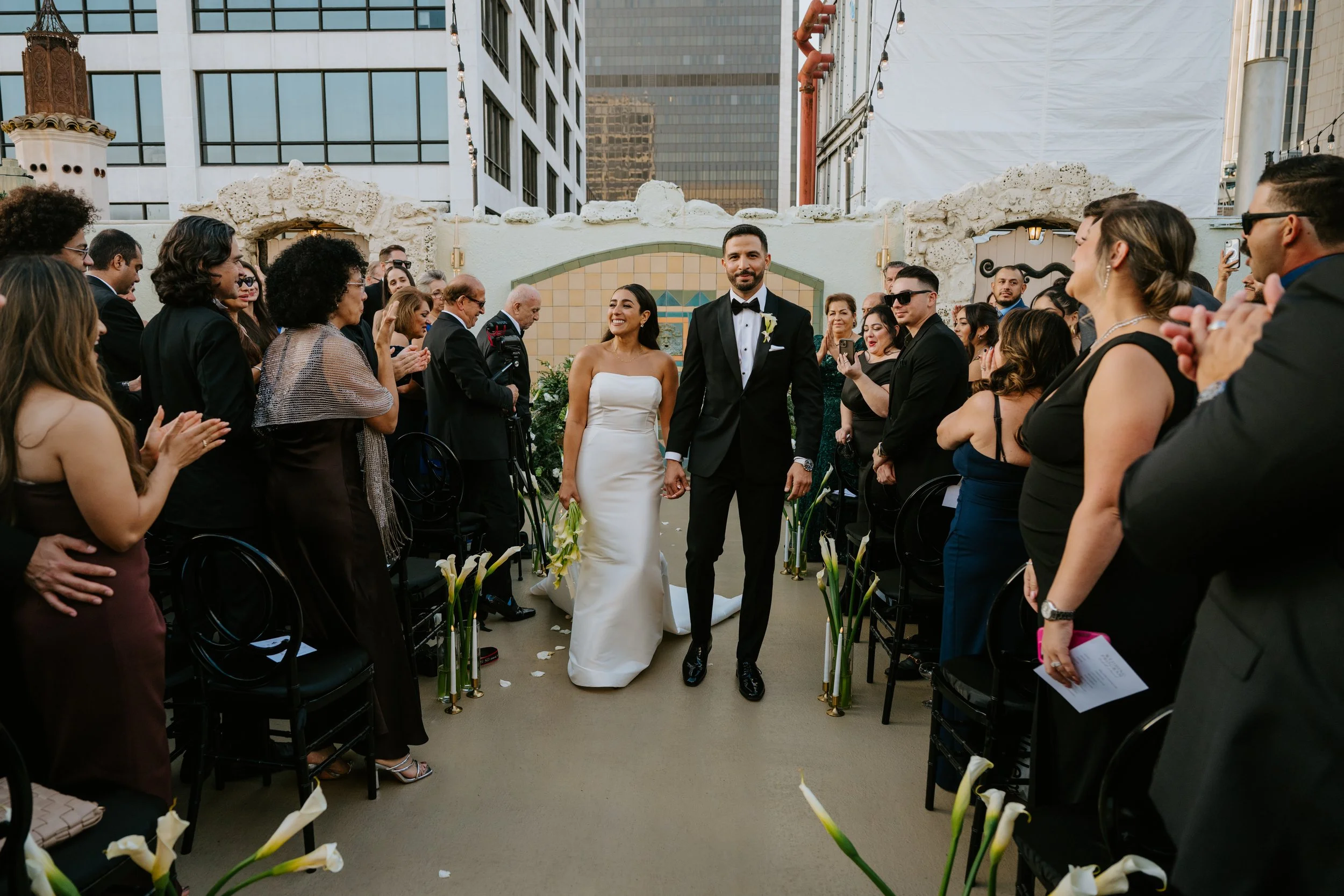 Bride and Groom walking back down the aisle from their ceremony as guest cheer