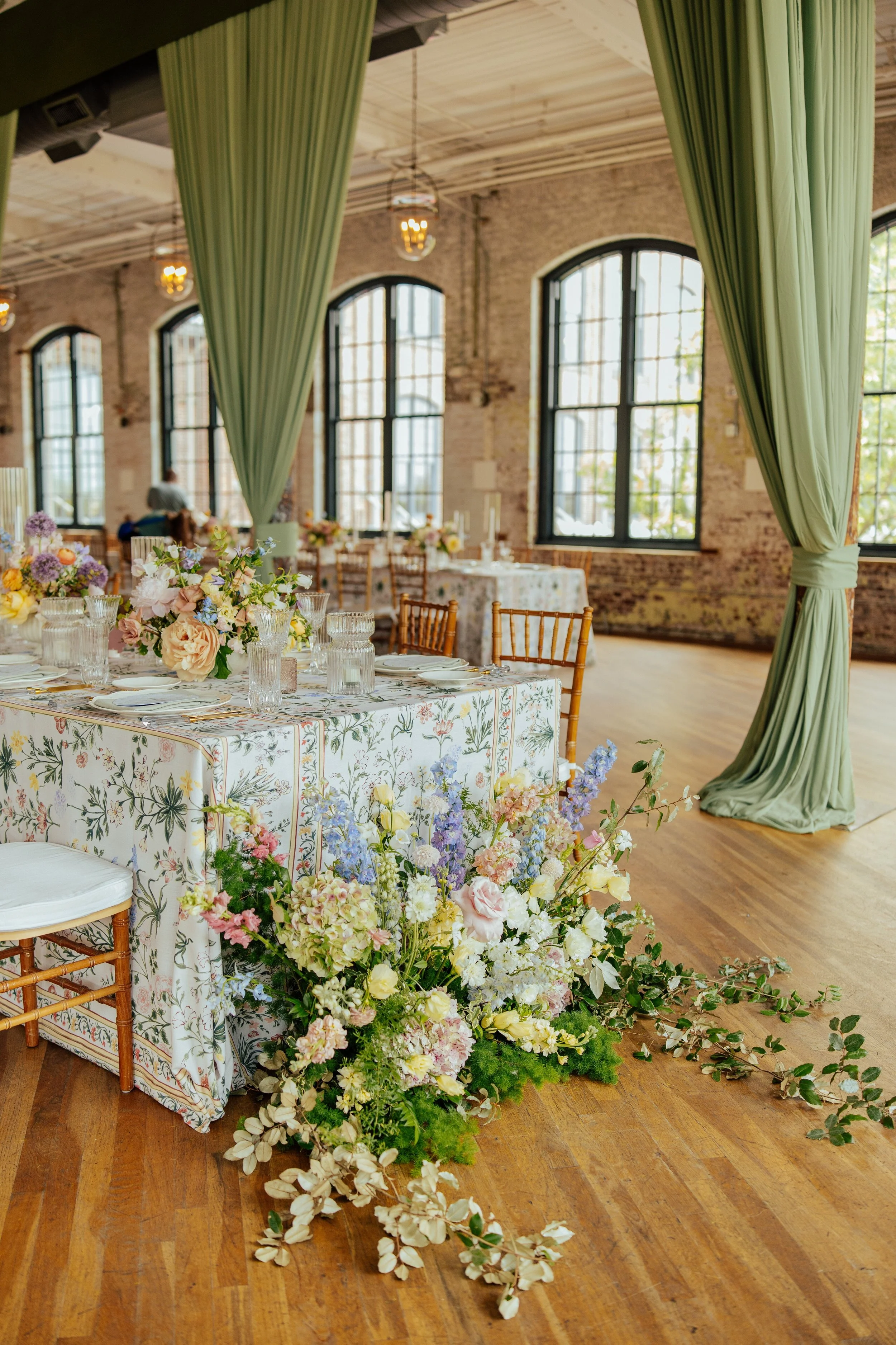 close up of pastel floral arrangement at the end of a table