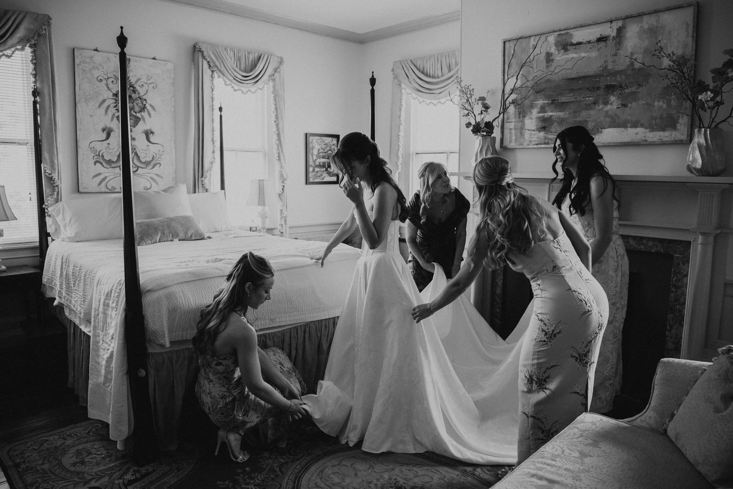 Black and white photos of woman helping a bride get ready in a bedroom